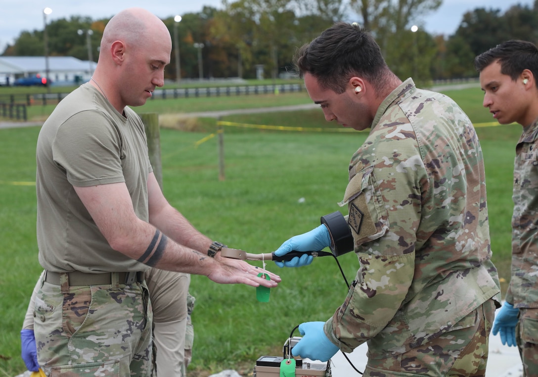 Army Sgt. Jacob Meenan, a non-commissioned officer with the 20th CBRNE Command, uses radiological detection equipment while simulating real-world safety procedures should any personnel enter a potentially contaminated area.