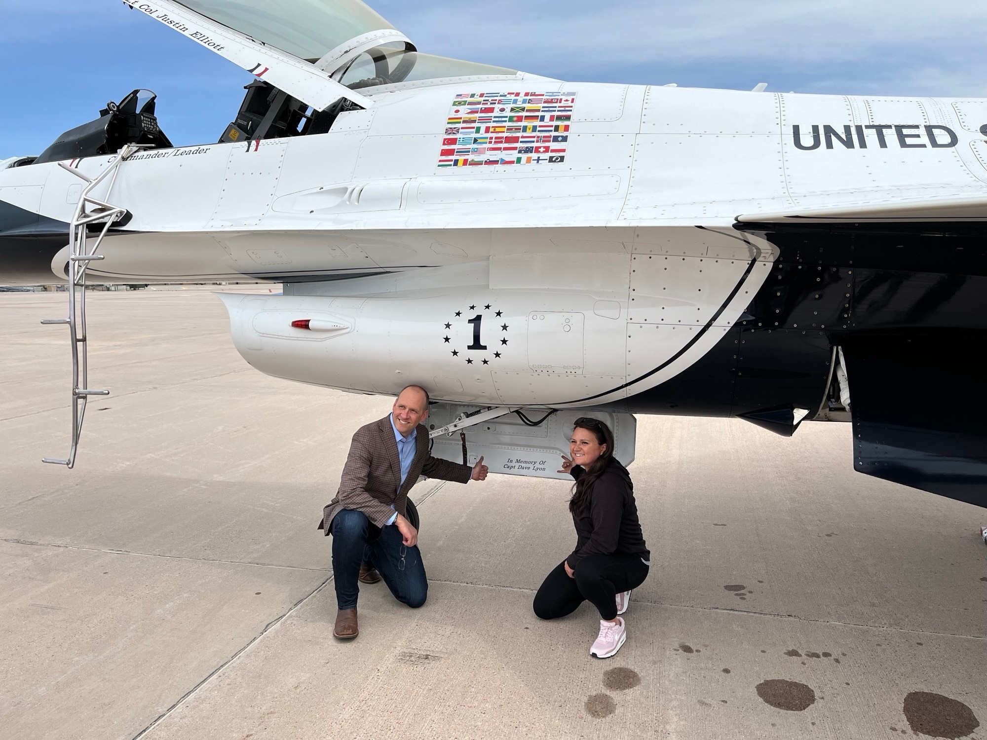 Dana Lyon, Capt. Lyon’s widow, and Jim Lovewell, Capt. Lyon’s former commander, pose for a photo next to Lyon's name painted inside the Thunderbird 1 nose wheel well.