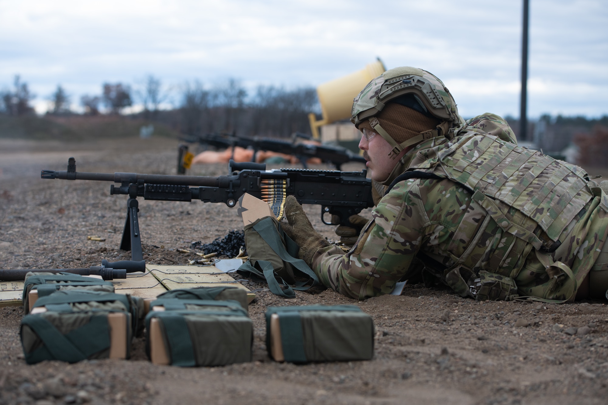 Man aims machine gun.