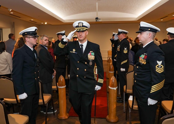 Cmdr. Michael Huber salutes sideboys as he exits the change of command ceremony for the Pre-Commissioning Unit (PCU) Arkansas (SSN 800) at the Mariners’ Museum and Park in Newport News, Virginia.