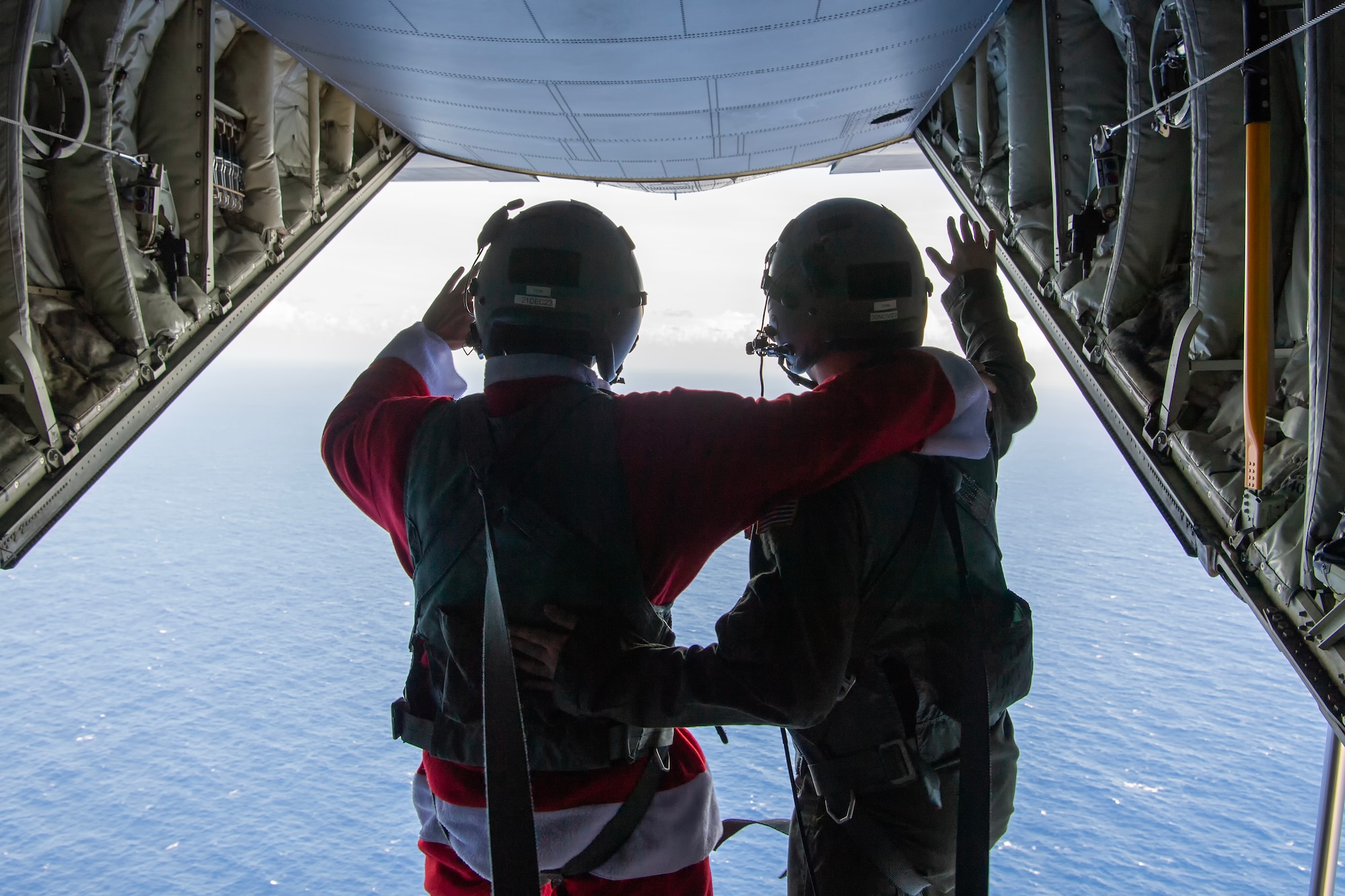 Photo of U.S. Air Force pilots waving from the back of a cargo aircraft