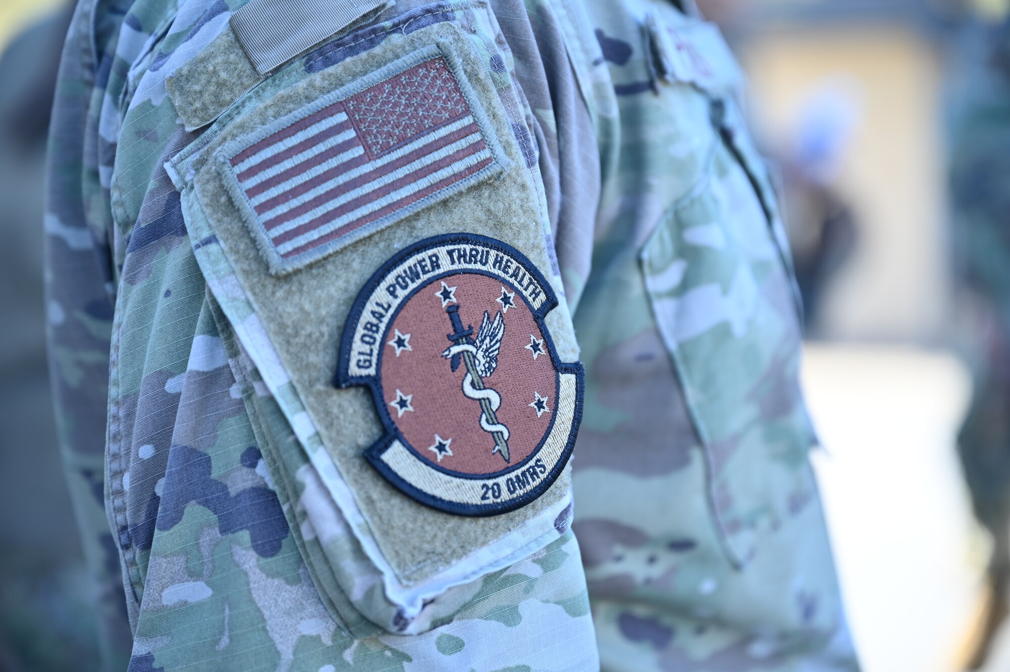A unit patch illustrating a sword with a snake wrapped around worn by a service member