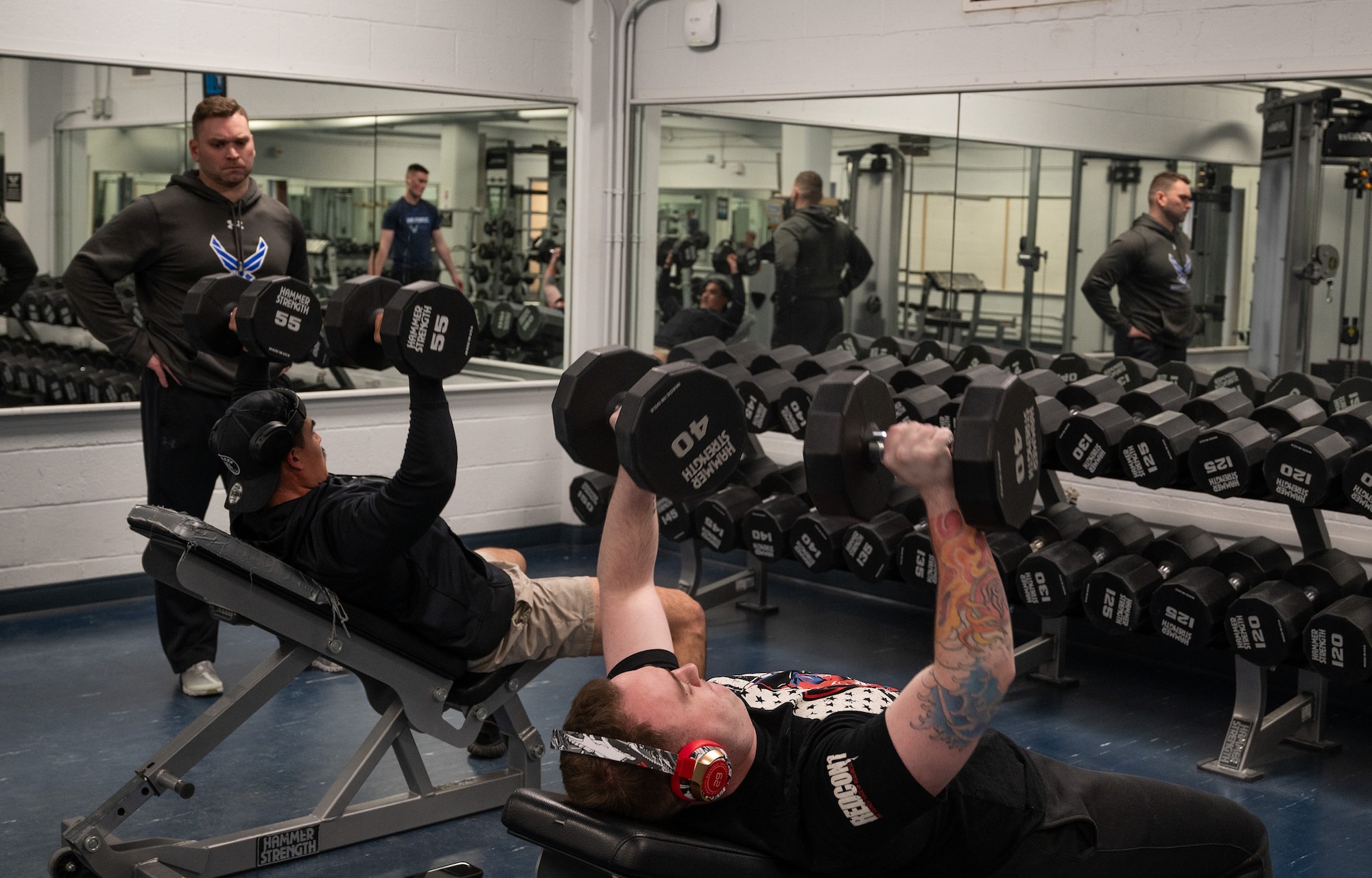 U.S. Air Force Maj. Miles Stutes, 354th Medical Group Operational Support Team physical therapist (left) supervises a physical training session with members from the 354th Security Forces Squadron.
