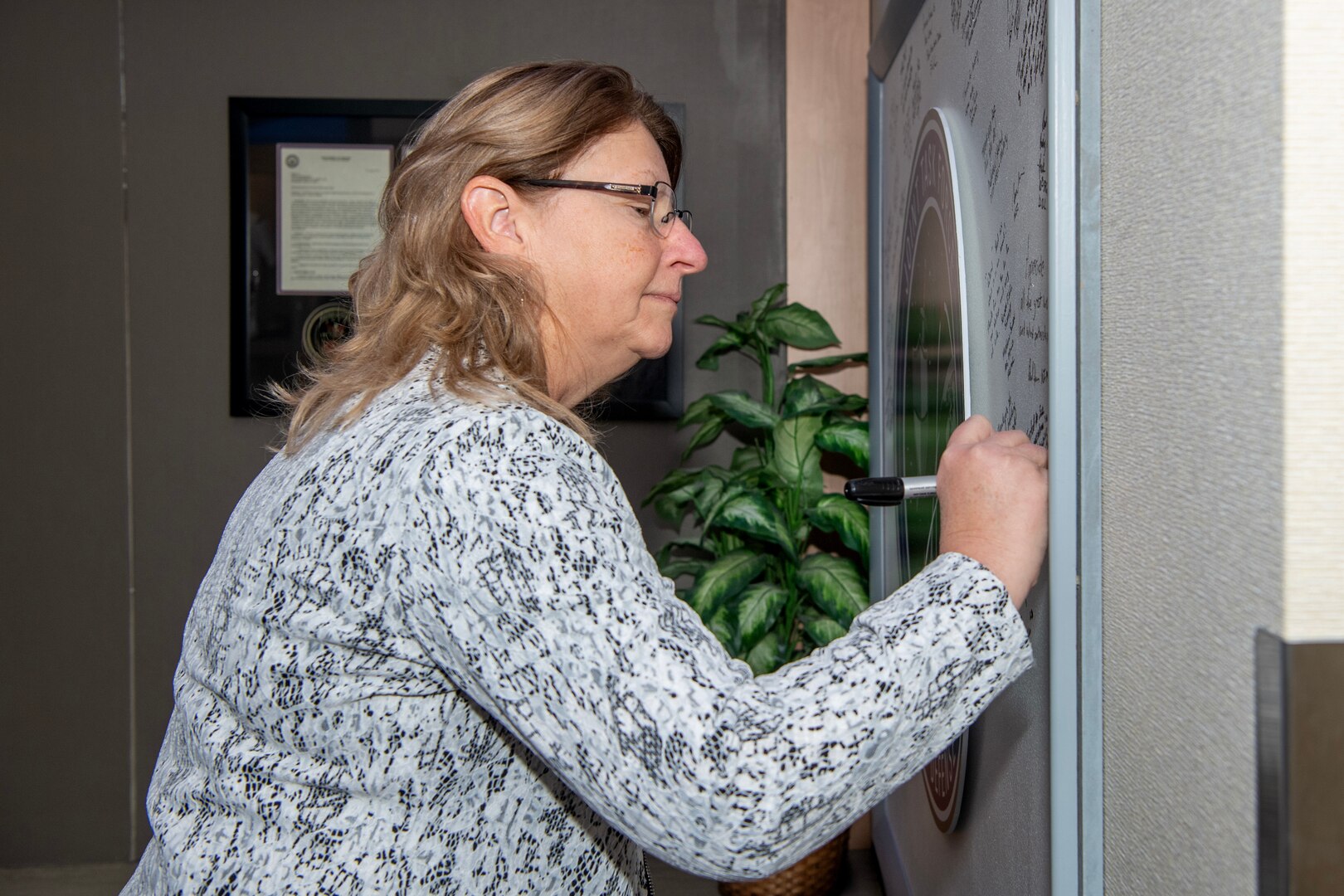 woman signing board