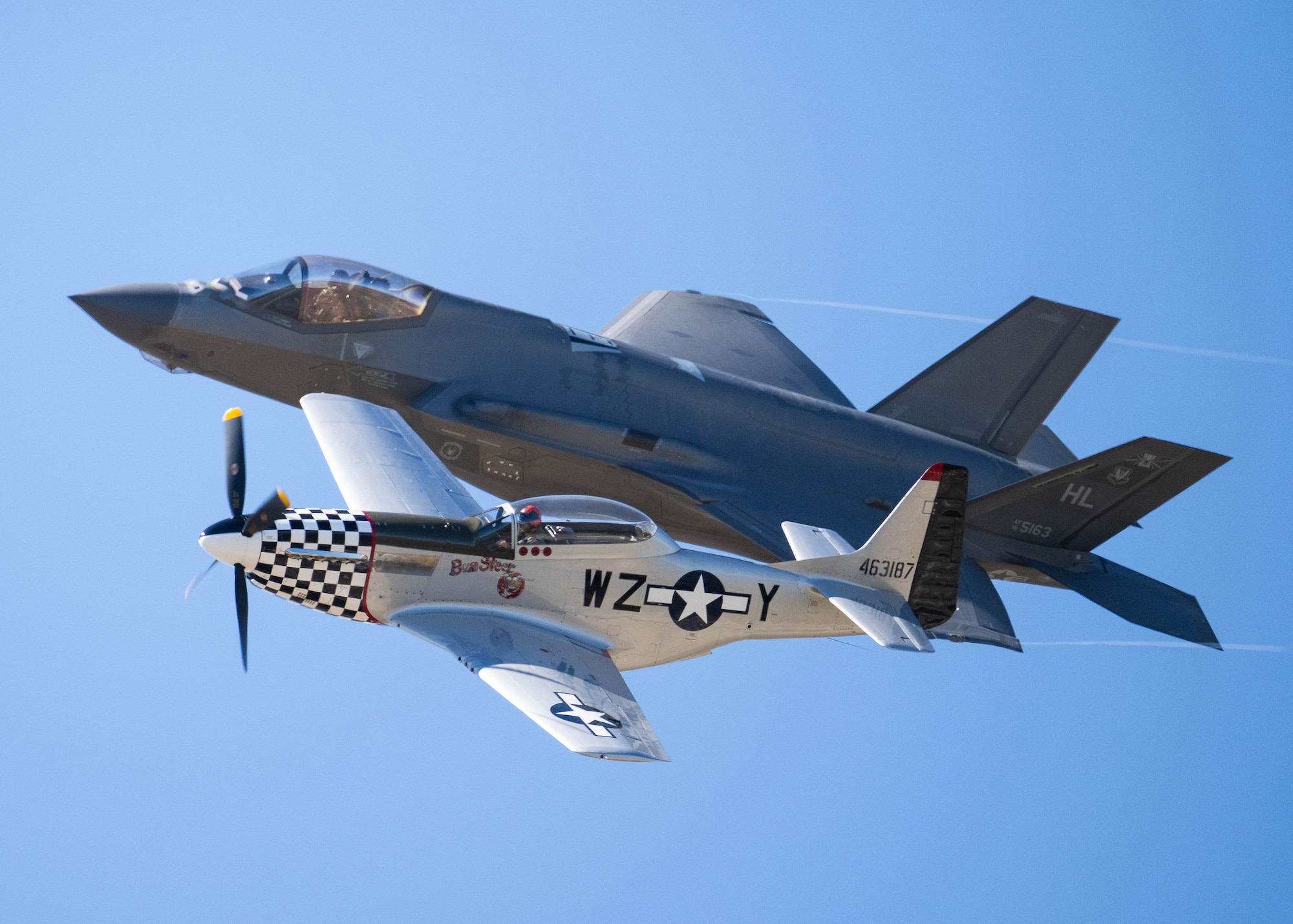 U.S. Air Force Maj. Kristin “BEO” Wolfe, F-35A Lightning II Demonstration Team pilot and commander, flies an F-35 assigned to the 421st Fighter Generation Squadron beside an Air Force Heritage Flight P-51.