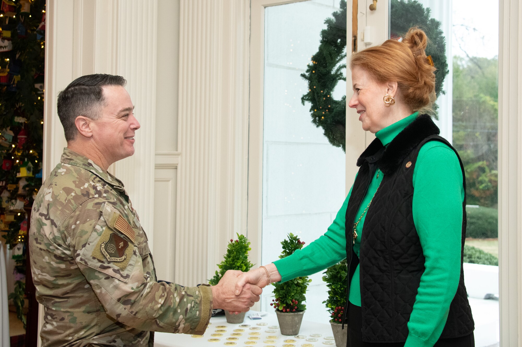 Lee Sellers, Director of Special Projects, Office of Governor Kay Ivey, presents the Governor’s challenge coin to Col. Jeremy Bergin, Commander, 27th Special Operations Wing