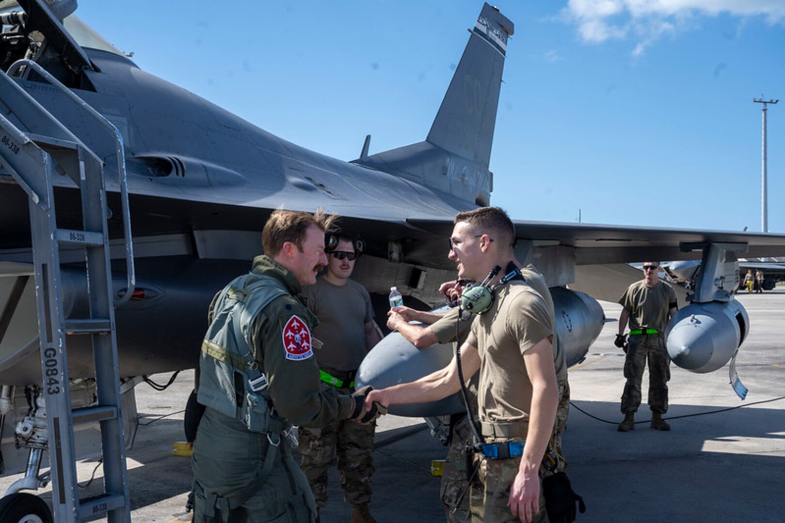 Photo of U.S. Air Force Senior Airman Joseph Lynch, crew chief, 140th Maintenance Group, Colorado Air National Guard greets U.S. Air Force Lt. Col. Daniel “Tracer” Way, pilot, 120th Fighter Squadron, 140th Wing, Colorado Air National Guard after Way lands at Tyndall Air Force Base, Florida, for Checkered Flag Oct. 25, 2023.