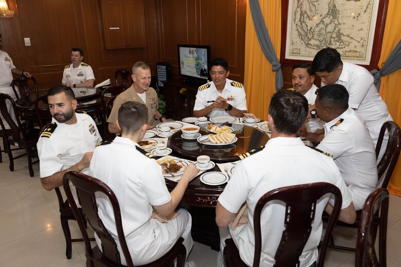 U.S. Marine Corps Col. Thomas Siverts, commanding officer of Marine Rotational Force-Southeast Asia, I Marine Expeditionary Force, sits down the with U.S. Navy Sailors assigned to the USS Manchester (LCS 14), Sailors with Destroyer Squadron,7 and Royal Malaysian Navy sailors with Western Fleet Command after the opening ceremony for Maritime Training Activity Malaysia at RMN Lumut Naval Base, Lumut, Malaysia, Nov. 1, 2023. The ceremony marked the beginning of MTA Malaysia and was attended by sailors from the Royal Malaysian Navy, U.S. Navy and U.S. Marines. MTA Malaysia 2023 highlights the 4th iteration of this series that allow the U.S. and Royal Malaysian navies to work together, enhancing maritime security and capabilities in the full range of maritime warfare. MRF-SEA is a Marine Corps Forces Pacific operational model, which involves planned exchanges with subject matter experts, promotes security goals with Allies and partners and positions I MEF forces west of the International Date Line. (U.S. Marine Corps photo by Staff Sgt. Kai W. Huber)