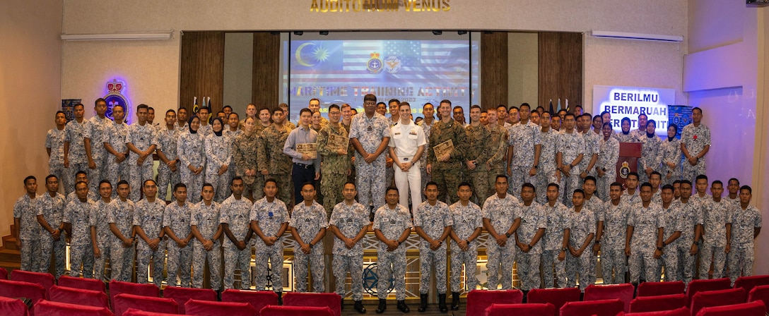 U.S. Marines with Marine Rotational Force-Southeast Asia, I Marine Expeditionary Force, British Royal Marines with 30 Commando Information Exploitation Group and Royal Malaysian Navy sailors with Western Fleet Command pose for a group photo after a subject matter expert exchange during Maritime Training Activity Malaysia 2023 at Lumut Naval Base, Lumut, Malaysia, Nov. 2, 2023. The exchange focused on applying both MDA and Expeditionary Advanced Base Operations to achieve a littoral advantage. MTA Malaysia 2023 highlights the 4th iteration of the exercise as one of many exercises that allow the U.S. and Royal Malaysian navies to work together, enhancing maritime security and capabilities in the full range of maritime warfare. MRF-SEA is a Marine Corps Forces Pacific operational model, which involves planned exchanges with subject matter experts, promotes security goals with Allies and partners and positions I MEF forces west of the International Date Line. (U.S. Marine Corps photo by Staff Sgt. Kai W. Huber)