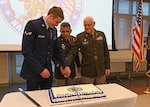 The youngest member of the New Hampshire National Guard, Airman 1st Class Keegan Werner of the 157th Air Refueling Wing, joins NH Adjutant Gen. David Mikolaities and the oldest member, Army Col. James Kelly of Joint Force Headquarters, for a birthday cake-cutting ceremony Dec. 13, 2023, at the Edward Cross Training Complex in Pembroke, N.H.