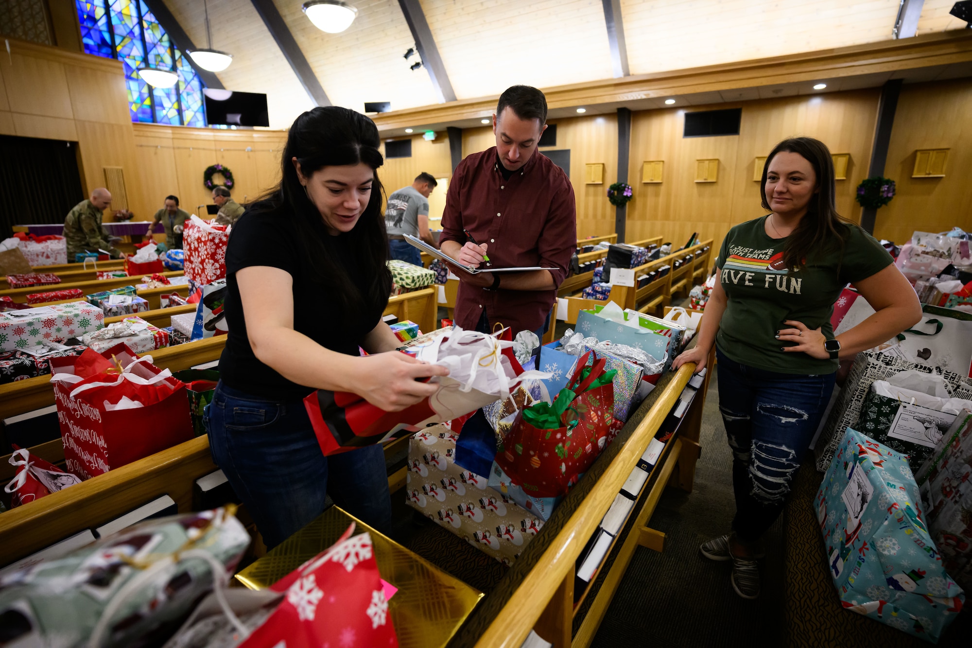 Hundreds of wrapped Christmas presents are sorted on pews in the chapel.