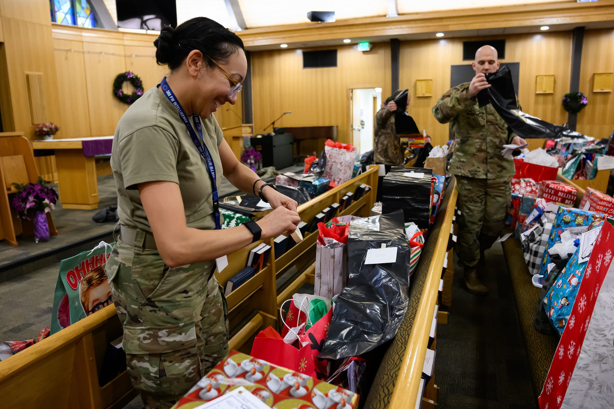 Hundreds of wrapped Christmas presents are sorted on pews in the chapel.