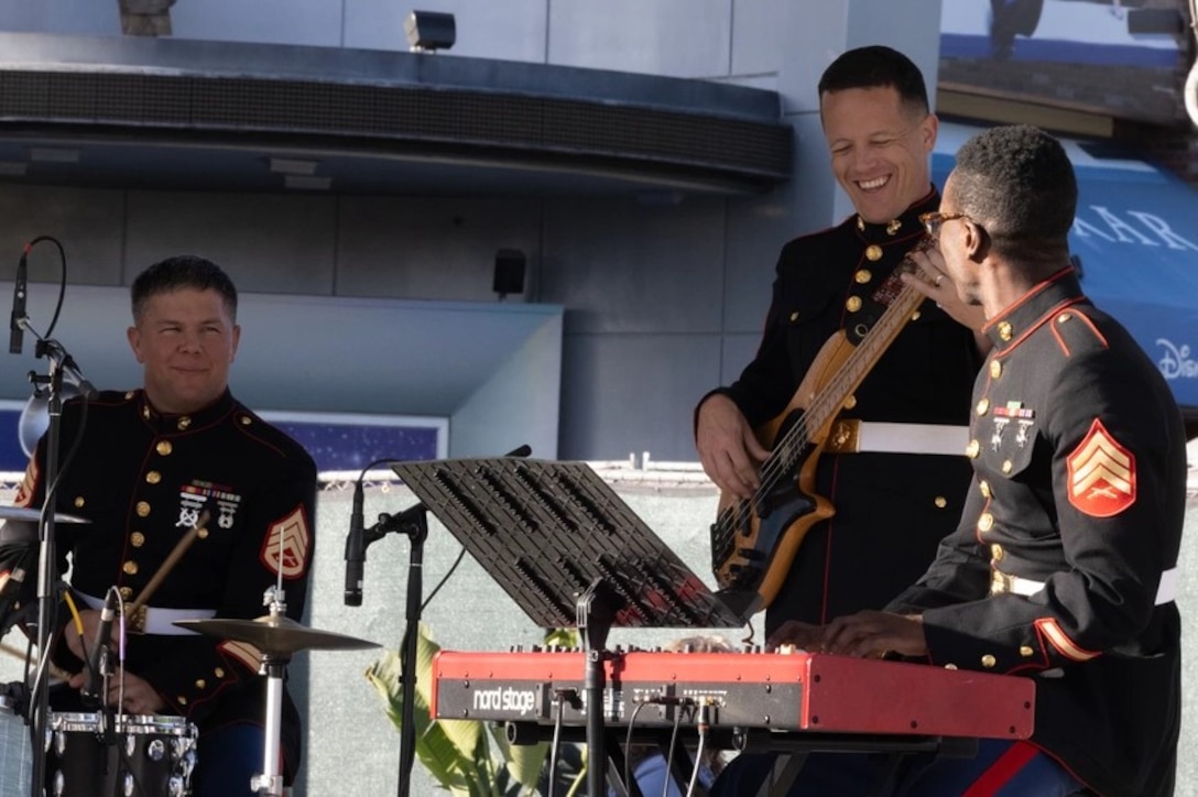 Marines in dress uniforms perform contemporary music on a stage at downtown disney