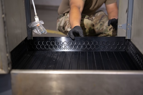 Airman install 3D printed floor panel that goes inside of the lavatory