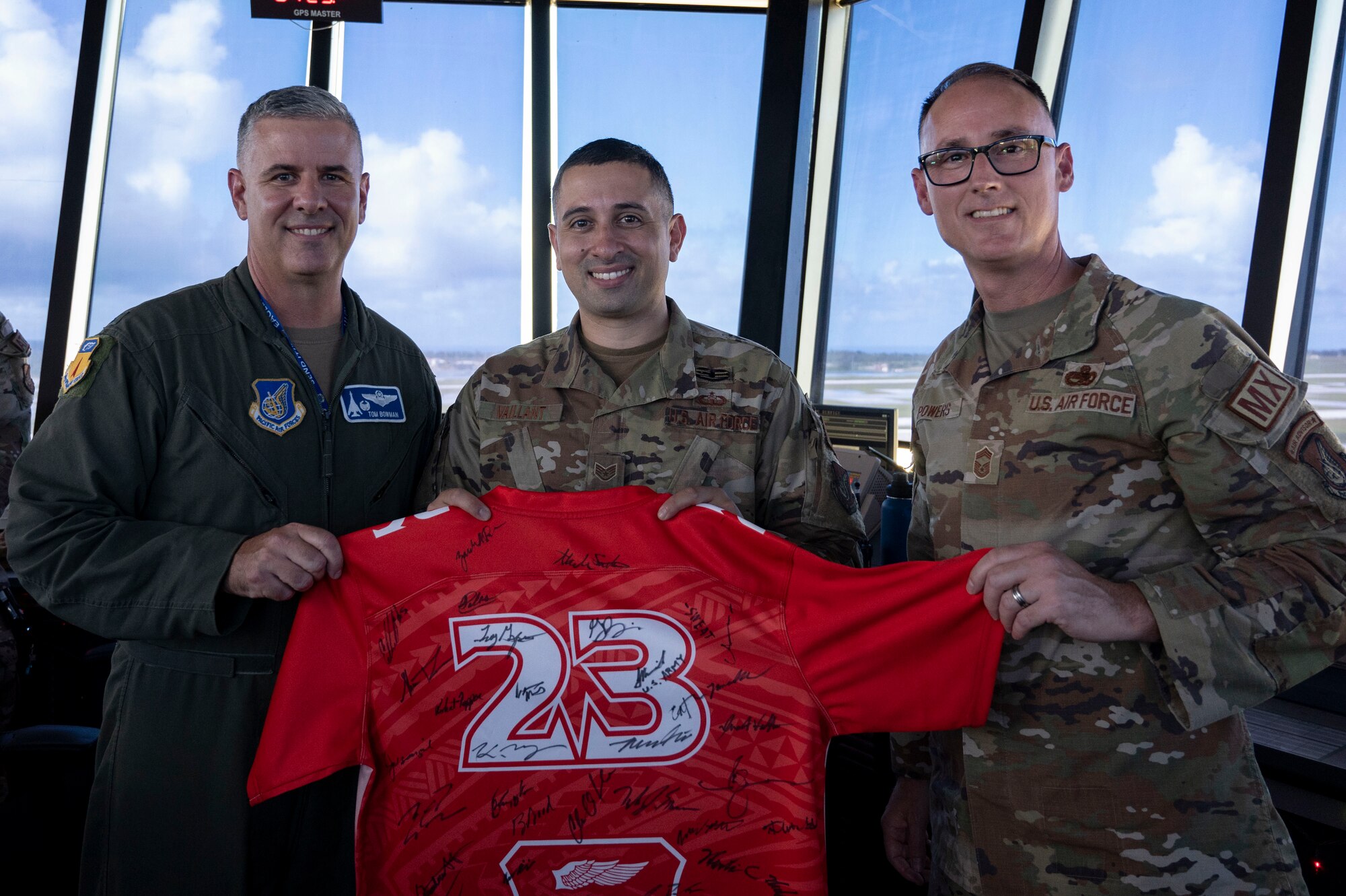 U.S. Air Force Staff Sgt. Justin Vaillant, the air traffic control tower senior watch supervisor, receives the Linebacker of the Week Award from U.S. Air Force Col. Thomas Bowman, commander of the 36th Operations Group, and Chief Master Sgt. Daniel Powers, the senior enlisted leader of the 36th Maintenance Group, at Andersen Air Force Base, Guam, Dec. 6, 2023. The Team Andersen Linebacker of the Week recognizes outstanding enlisted, officer, civilian and total force personnel who have had an impact on achieving Team Andersen’s mission, vision and priorities. (U.S. Air Force photo by Senior Airman Emily Saxton)