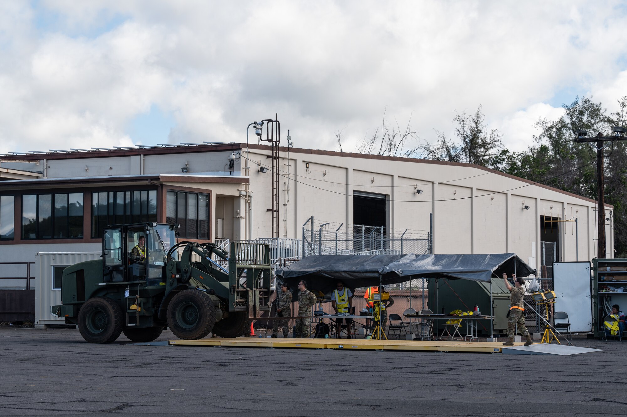 Airmen assigned to Joint Base Pearl Harbor-Hickam measure the weight of a forklift during the Readiness Exercise 24-01 at JBPHH, Hawaii, Dec. 12, 2023. Team Hickam trains to operate, fight, and advance its capabilities through realistic training exercises designed to test and develop joint logistics, resilience and rapid strategic mobility. (U.S. Air Force photo by Staff Sgt. Alan Ricker)