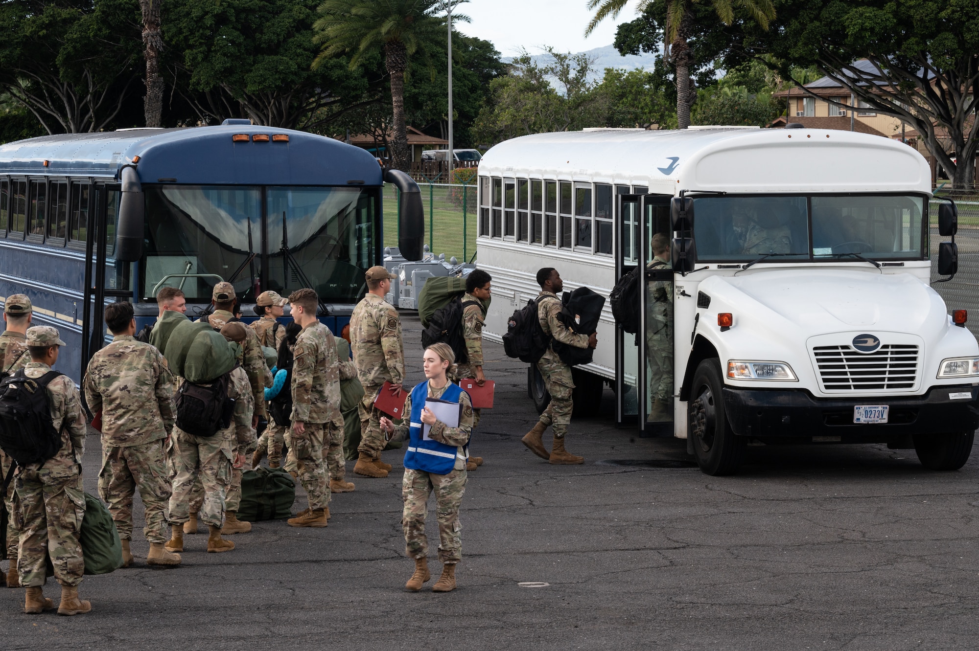 Airmen assigned to Joint Base Pearl Harbor-Hickam board a bus during the Readiness Exercise 24-01 at JBPHH, Hawaii, Dec. 12, 2023. The RE provides realistic training in various operations, enabling our Airmen to provide distinct tools and capabilities needed for mission success in an ever-changing theater. (U.S. Air Force photo by Staff Sgt. Alan Ricker)