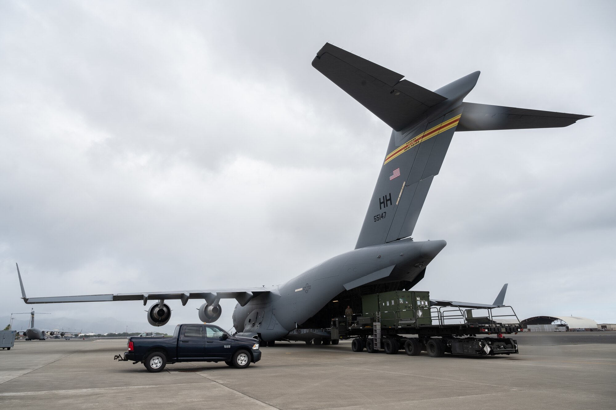 Airmen assigned to Joint Base Pearl Harbor-Hickam, load cargo onto a C-17 Globemaster III during the Readiness Exercise 24-01 at JBPHH, Hawaii, Dec. 12, 2023. The RE provides realistic training in various operations, enabling our Airmen to provide distinct tools and capabilities needed for mission success in an ever-changing theater. (U.S. Air Force photo by Staff Sgt. Alan Ricker)