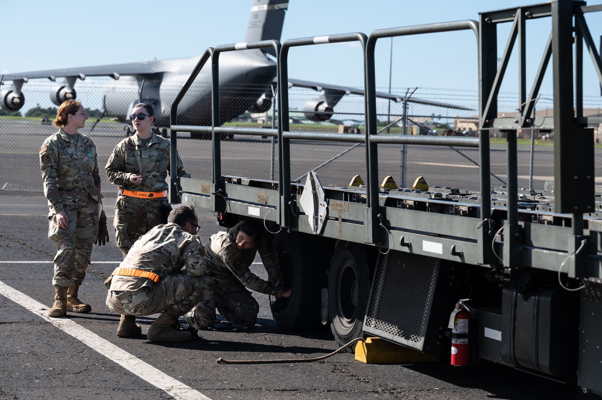 Airmen assigned to Joint Base Pearl Harbor-Hickam perform joint airdrop inspection on a cargo k-loader during the Readiness Exercise 24-01 at JBPHH, Hawaii, Dec. 12, 2023. The 15th Wing trains to operate, fight and advance its capabilities through realistic training exercises designed to test and develop joint logistics, resilience and rapid strategic mobility. (U.S. Air Force photo by Staff Sgt. Alan Ricker)
