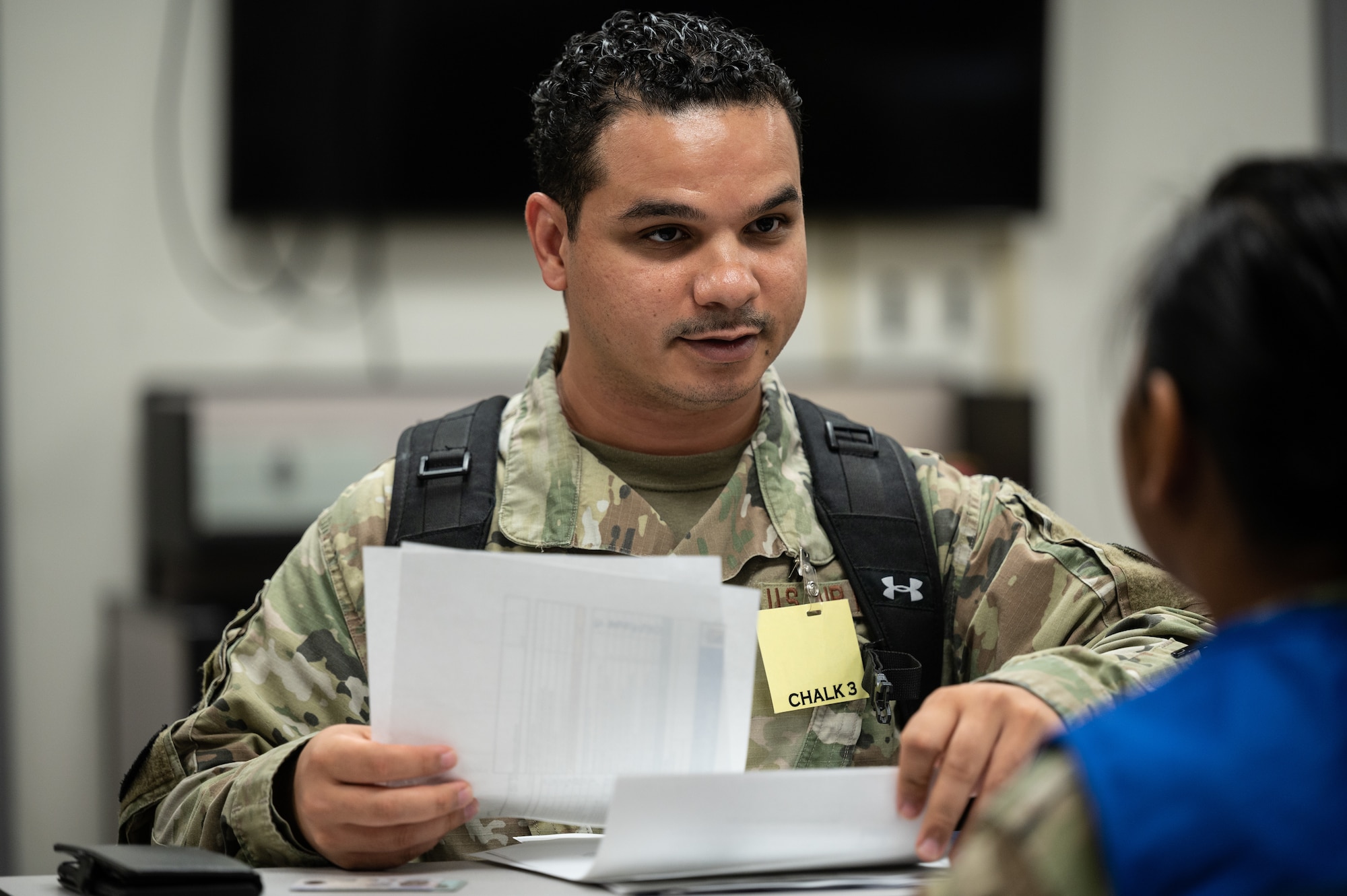 Staff Sgt. Travis Carbonell, 15th Comptroller Squadron financial analyst, processes through a pre-deployment function line during the Readiness Exercise 24-01 at JBPHH, Hawaii, Dec. 12, 2023. The 15th Wing trains to operate, fight and advance its capabilities through realistic training exercises designed to test and develop joint logistics, resilience and rapid strategic mobility. (U.S. Air Force photo by Staff Sgt. Alan Ricker)