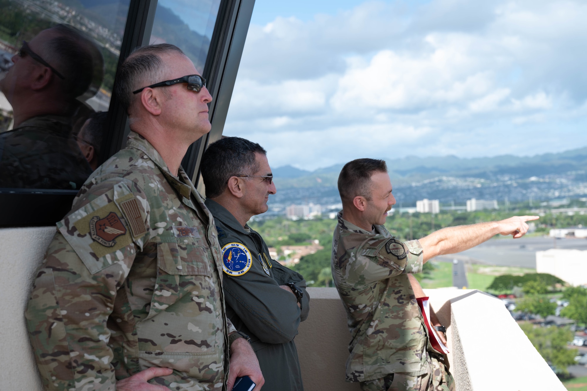 U.S. Air Force Lt. Col. Justin Van Patton, 15th Operations Support Squadron commander, briefs U.S. Air Force Lt. Gen. David Nahom, commander of Alaskan NORAD Region, Alaskan Command and Eleventh Air Force, and U.S. Air Force Chief Master Sgt. Heath Tempel, senior enlisted leader, Alaskan NORAD Region and Alaskan Command, and command chief, Eleventh Air Force, during a tour of the 15th Wing at Joint Base Pearl Harbor-Hickam, Hawaii, Dec. 7, 2023. Nahom and Tempel gained an in-depth understanding of the 15th Wing's capabilities, and recognized multiple Airmen for their above-the-bar efforts.. (U.S. Air Force photo by 2nd Lt. Margaret Blice)