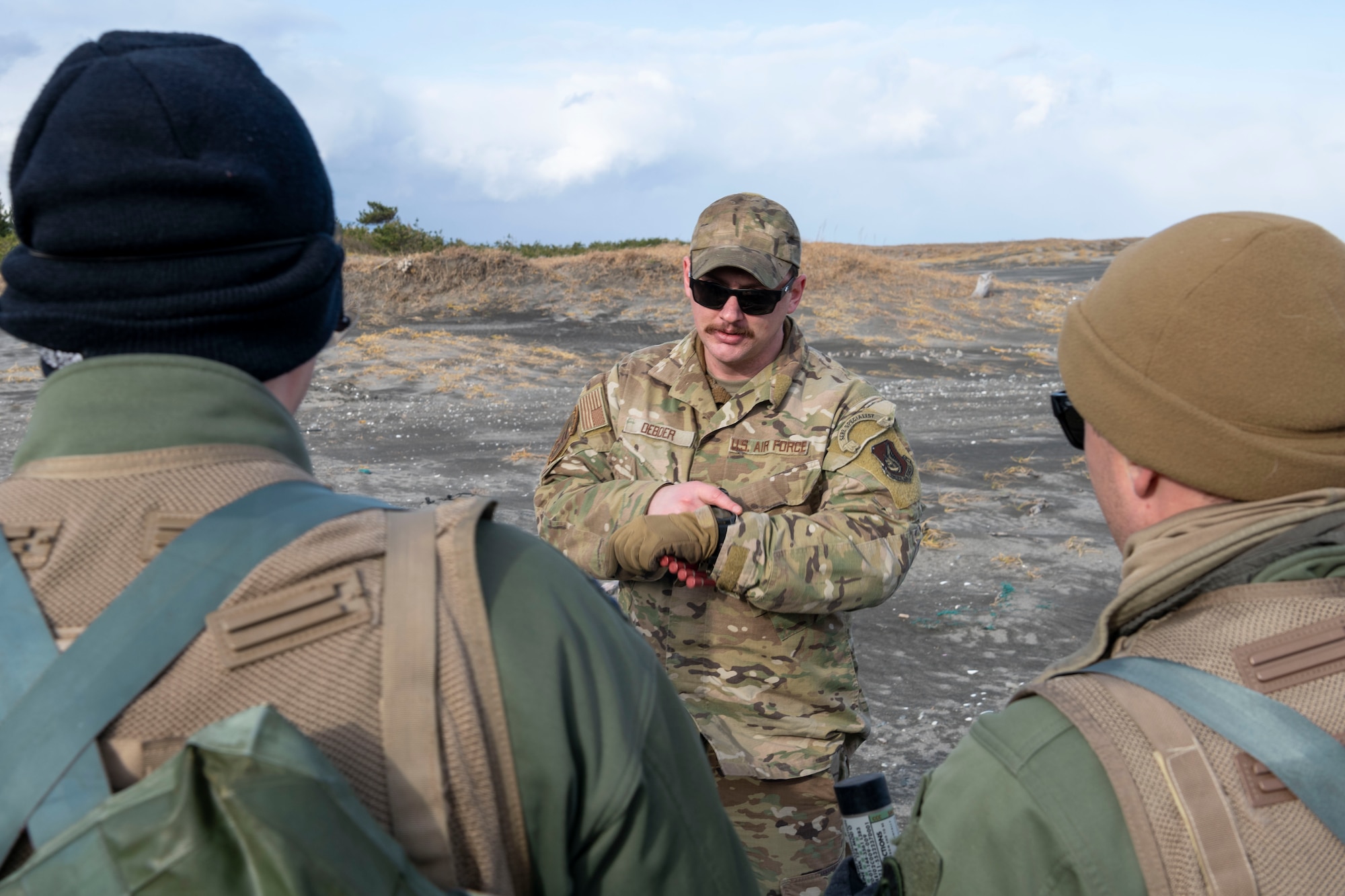 U.S. Air Force Staff Sgt. Dalton Deboer, 35th Operations Group Support Squadron survival, evasion, resistance and escape (SERE) specialist, briefs pilots before a combat survival skills training at Draughn Range near Misawa Air base, Japan