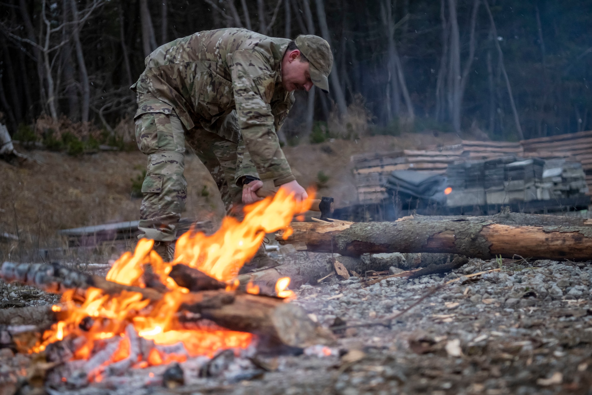 U.S. Air Force Staff Sgt. Dalton Deboer, 35th Operations Group Support Squadron survival, evasion, resistance and escape (SERE) specialist, chops wood for a fire during a fire building demonstration at Draughn Range near Misawa Air Base, Japan.
