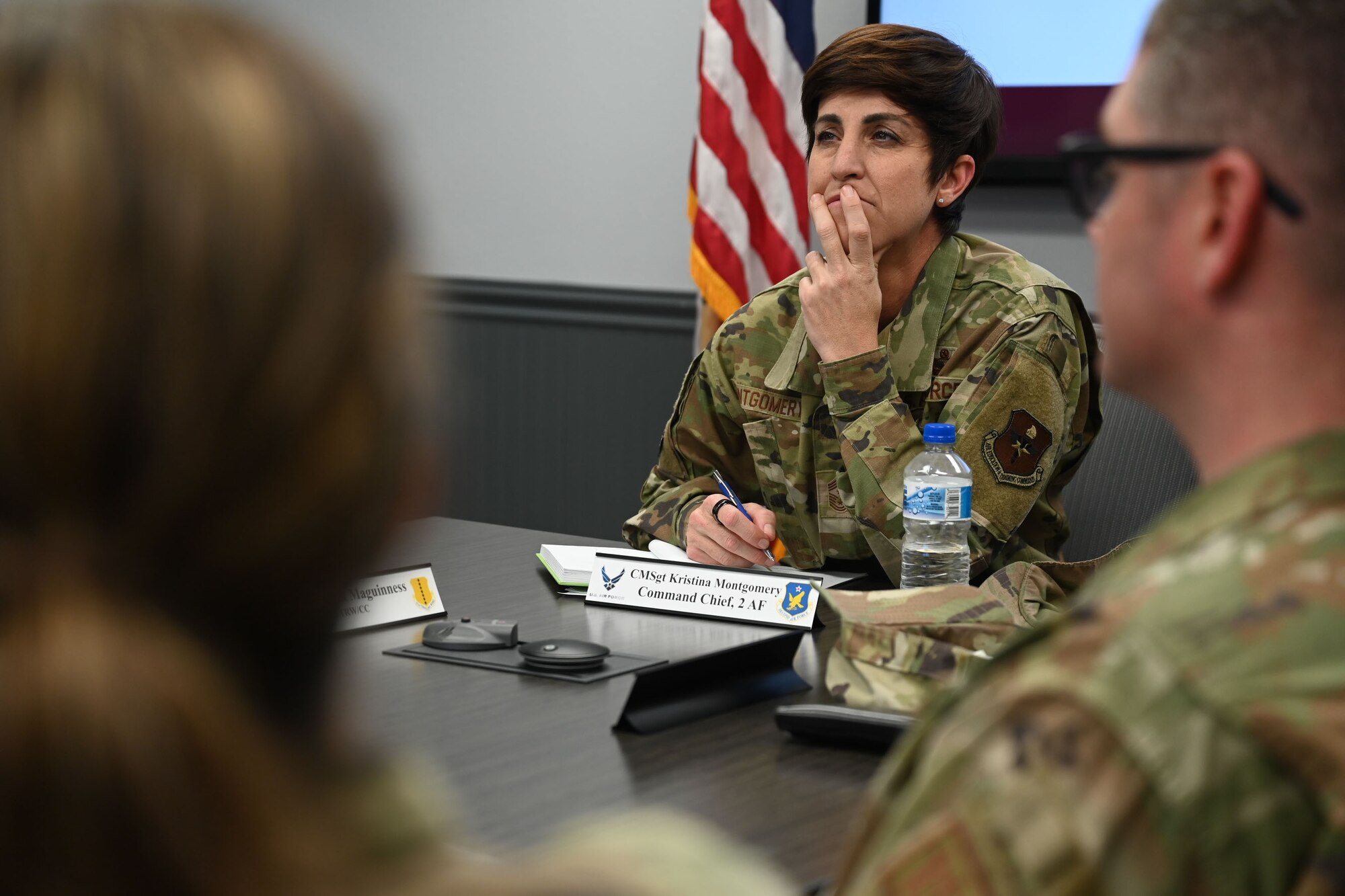 U.S. Air Force Chief Master Sgt. Kristina Montgomery, 2nd Air Force command chief, listens to the 17th Medical Group brief during her visit at the Ross Clinic, Goodfellow Air Force Base, Texas, Dec. 7, 2023. The briefing included the chain of command, everyday operations and the partnerships with medical professionals in the San Angelo community. (U.S. Air Force photo by Airman 1st Class Evelyn D’Errico)