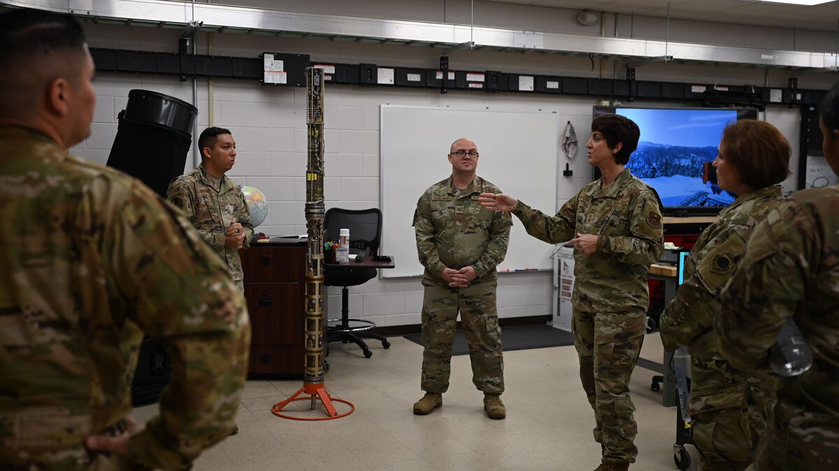 U.S. Air Force Chief Master Sgt. Kristina Montgomery, 2nd Air Force command chief, speaks to Staff Sgt. Christian Bufford and Tech. Sgt. Robert Kedrowski, 312th Training Squadron Special Instruments Training instructors, about the different technology used inside the schoolhouse at the Louis F. Garland Department of Defense Fire Academy, Goodfellow Air Force Base, Texas, Dec. 8, 2023. SPINSTRA is tasked with pushing the envelope of the Department of Defense’s capabilities, giving tactical forces, commanders and national decision-makers the advantage needed to take action when necessary. (U.S. Air Force photo by Airman 1st Class Evelyn D’Errico)