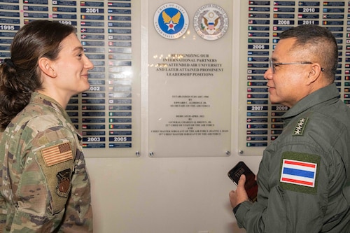 Captain Audrey Knickel, chief, Air University Protocol, and Royal Thai Air Force Commander-in-Chief Air Marshal Punpakdee Pattanakul search for the names of the 19 RTAF members posted to the Chief of Staff and Chief Master Sergeant of the Air Force International Honor Roll wall in the International Airmen Room at the Maxwell Event Center, Dec. 12, 2023, Maxwell Air Force Base, Alabama. Induction into the IHR pays tribute to officer and enlisted graduates who attain prominent positions in their respective country’s military or government. Punpakdee’s visit to Air University was a continuation of the Chief of Staff of the Air Force Counterpart Visits. The visits facilitate key leader engagements and highlight the service’s units, organizations and installations.