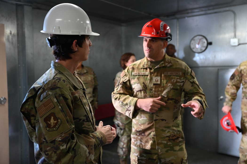 U.S. Air Force Chief Master Sgt. Kristina Montgomery, 2nd Air Force command chief, speaks with Master Sgt. Anthony Montano, 312th Training Squadron flight chief, about the different techniques students in training learn to carry out a building rescue at the Louis F. Garland Department of Defense Fire Academy, Goodfellow Air Force Base, Texas, Dec. 8, 2023. The 312th TRS is responsible for training the entire DoD’s fire emergency services and scientific applications specialists. (U.S. Air Force photo by Airman 1st Class Evelyn D’Errico)