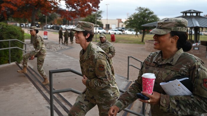 U.S. Air Force Chief Master Sgt. Kristina Montgomery, 2nd Air Force command chief, left, Chief Master Sgt. Khamillia Washington, 17th Training Wing command chief, right, walk into the Western Winds Dining Facility during Montgomery’s visit at Goodfellow Air Force Base, Texas, Dec. 8, 2023. The chiefs hosted an Airman’s Breakfast for permanent party junior enlisted members to have a candid conversation with them and build connections. (U.S. Air Force photo by Airman 1st Class Evelyn D’Errico)