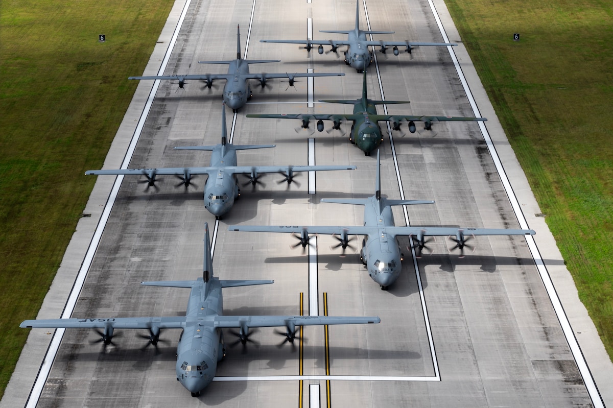 Six aircraft line a runway