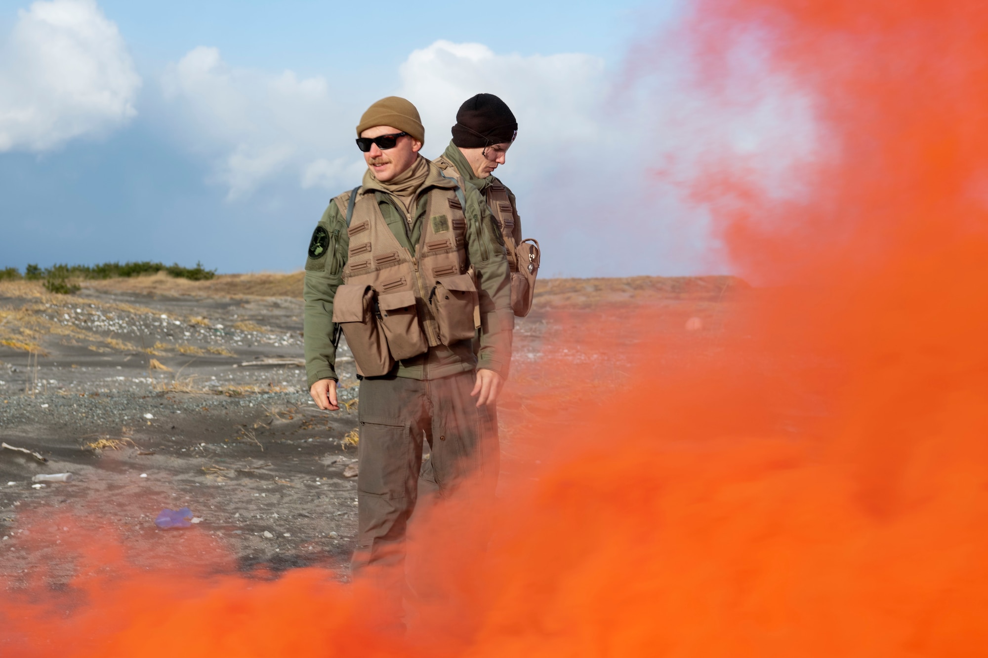 U.S. Air Force F-16 Fighting Falcon pilots lay down smoke flares to signal the start of a combat survival skills training exercise at Draughn Range near Misawa Air Base, Japan.