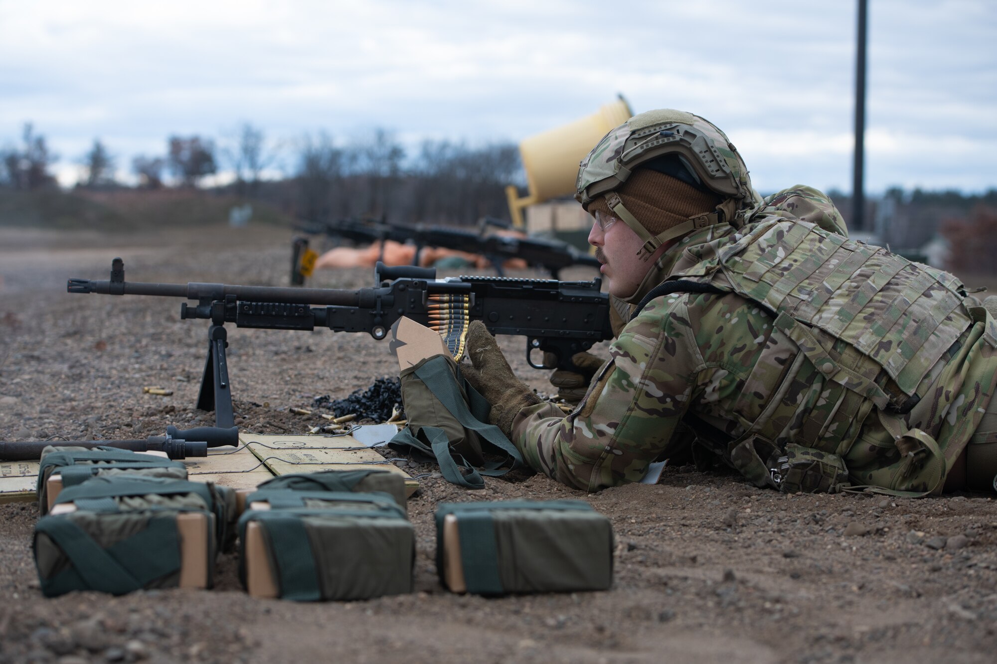 Man aims machine gun.