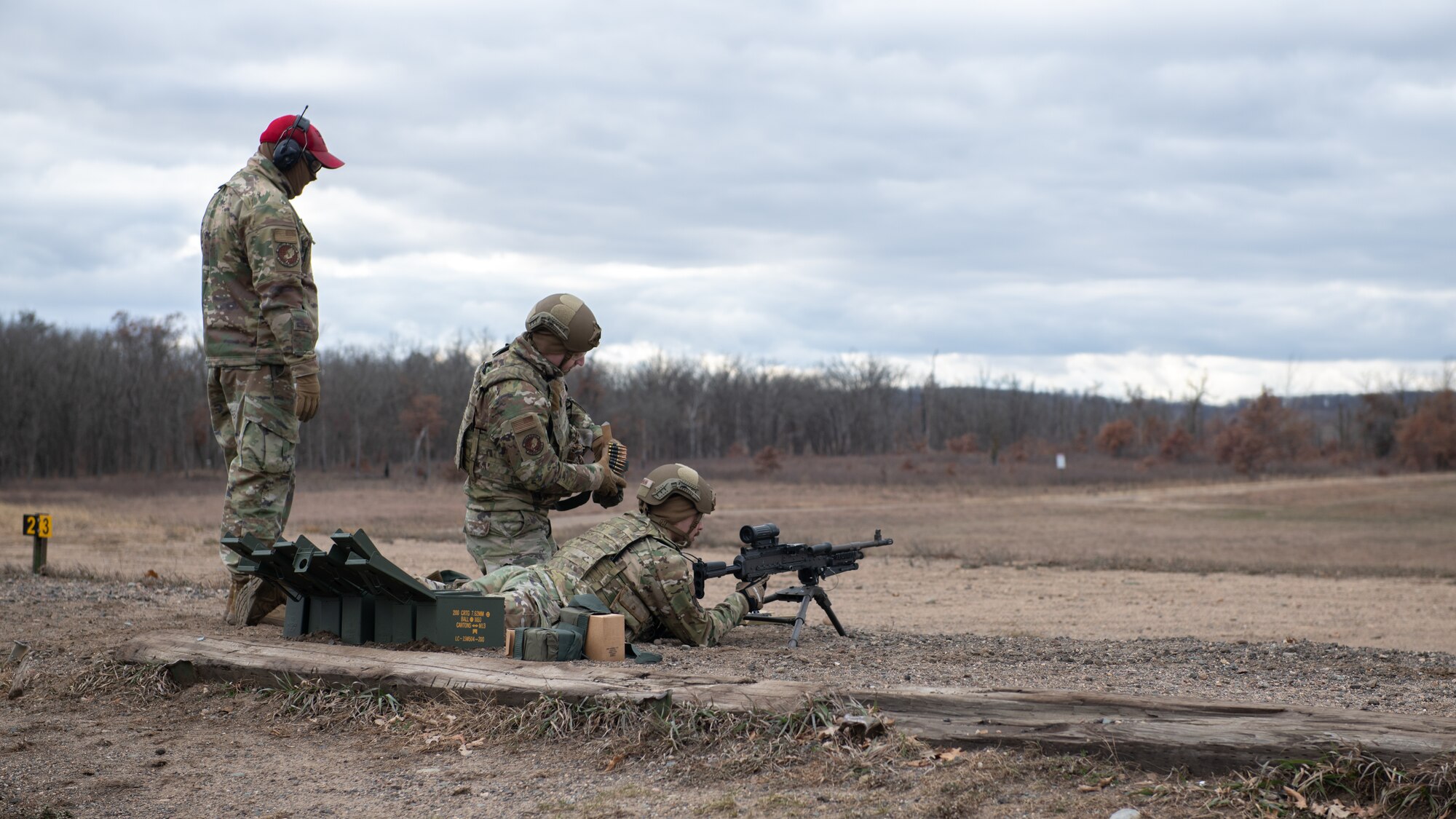 3 men are at a shooting range.