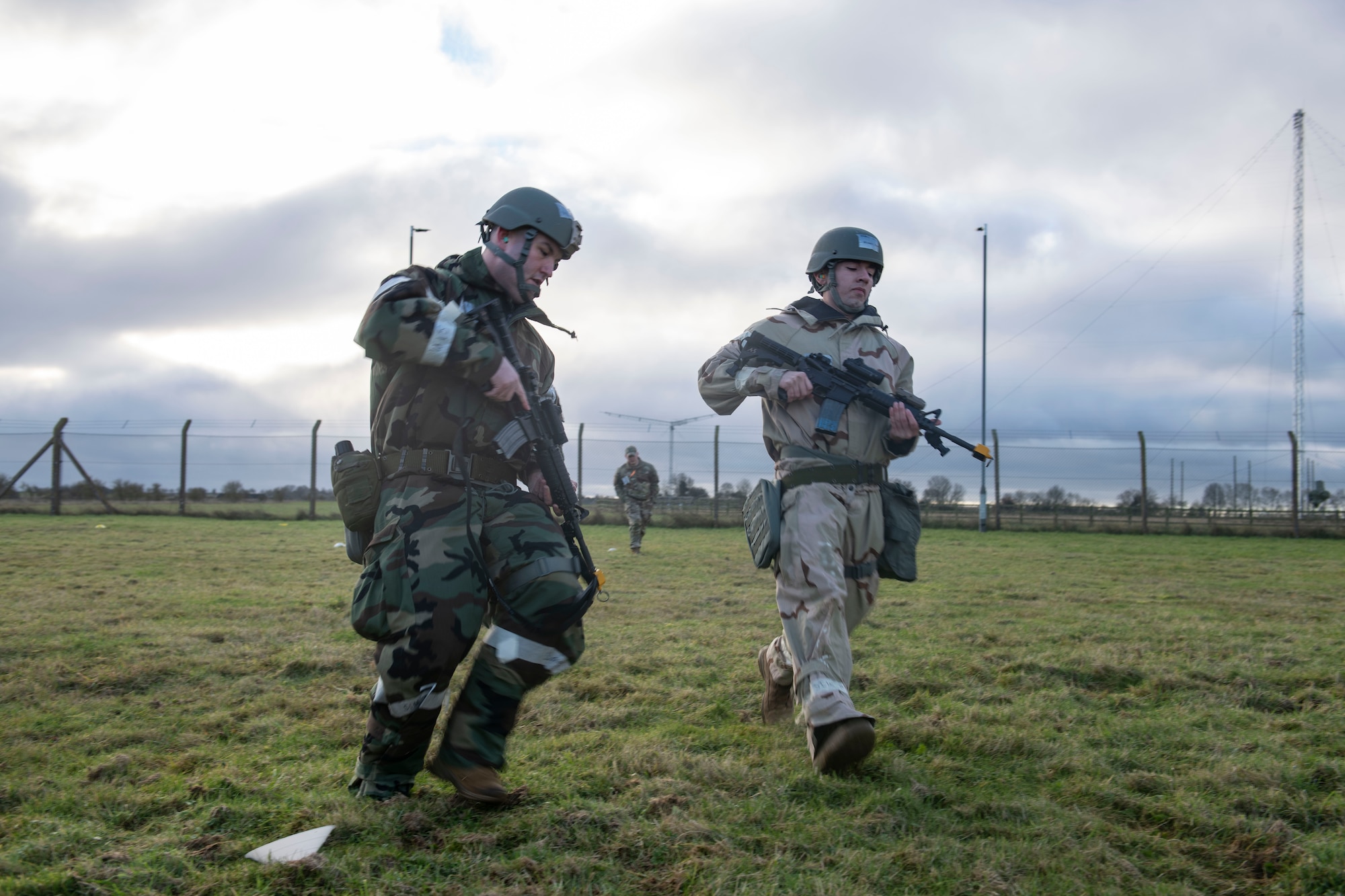 Airman 1st Class Michael Helm, 422d Communications Squadron noncommissioned officer in charge of client systems technician, left, and Airman 1st Class Mark Joseph Munoz, 422d CS network infrastructure technician, undergo shoot, move and communicate training at RAF Barford St. John