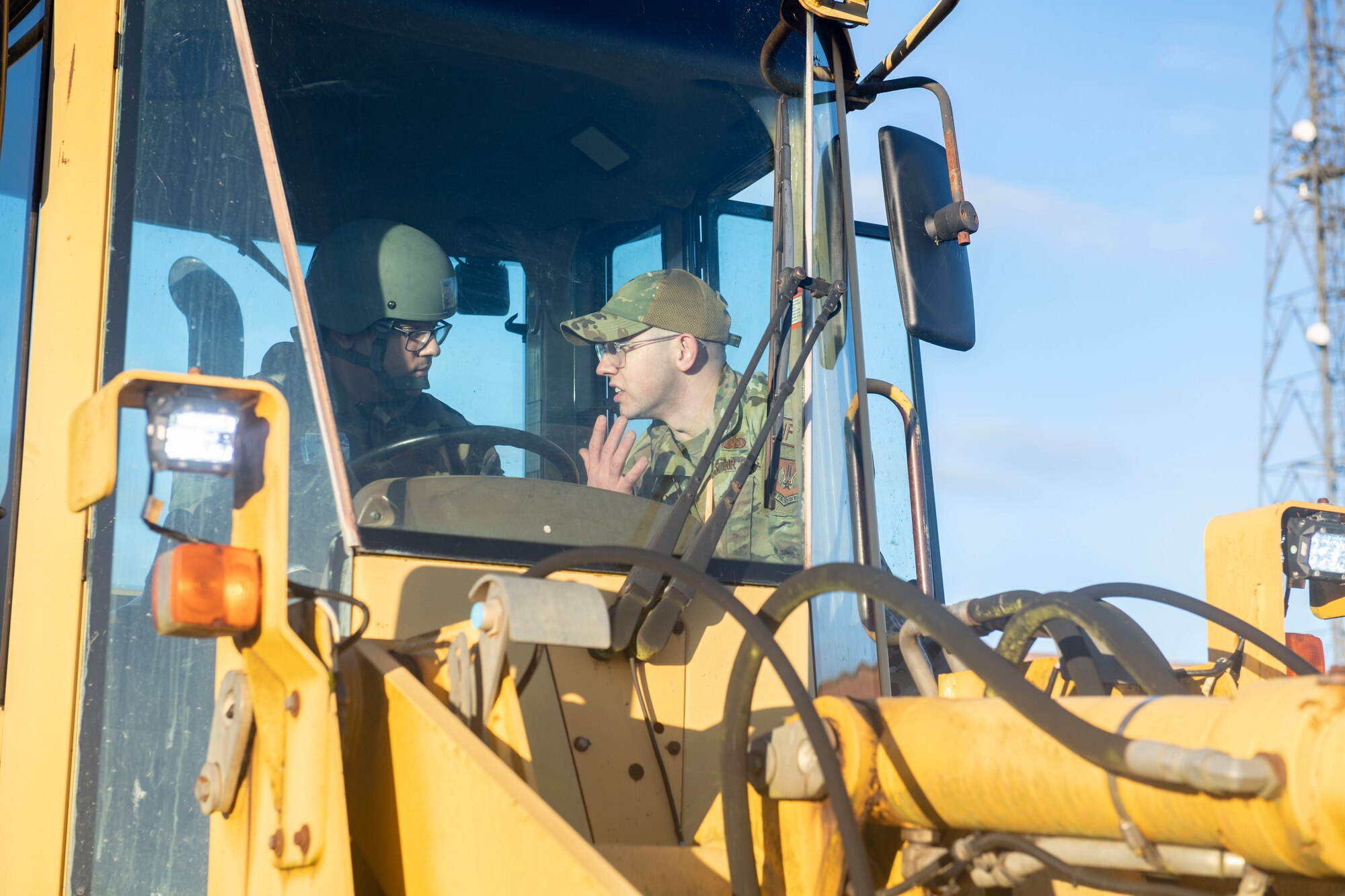 Master Sgt. Wesley Schamberger, 422d Communications Squadron special missions maintenance section chief, right, gives instruction to Airman 1st Class Pavan Vyas, 422d CS network infrastructure technician, on forklift operation at RAF Barford St. John