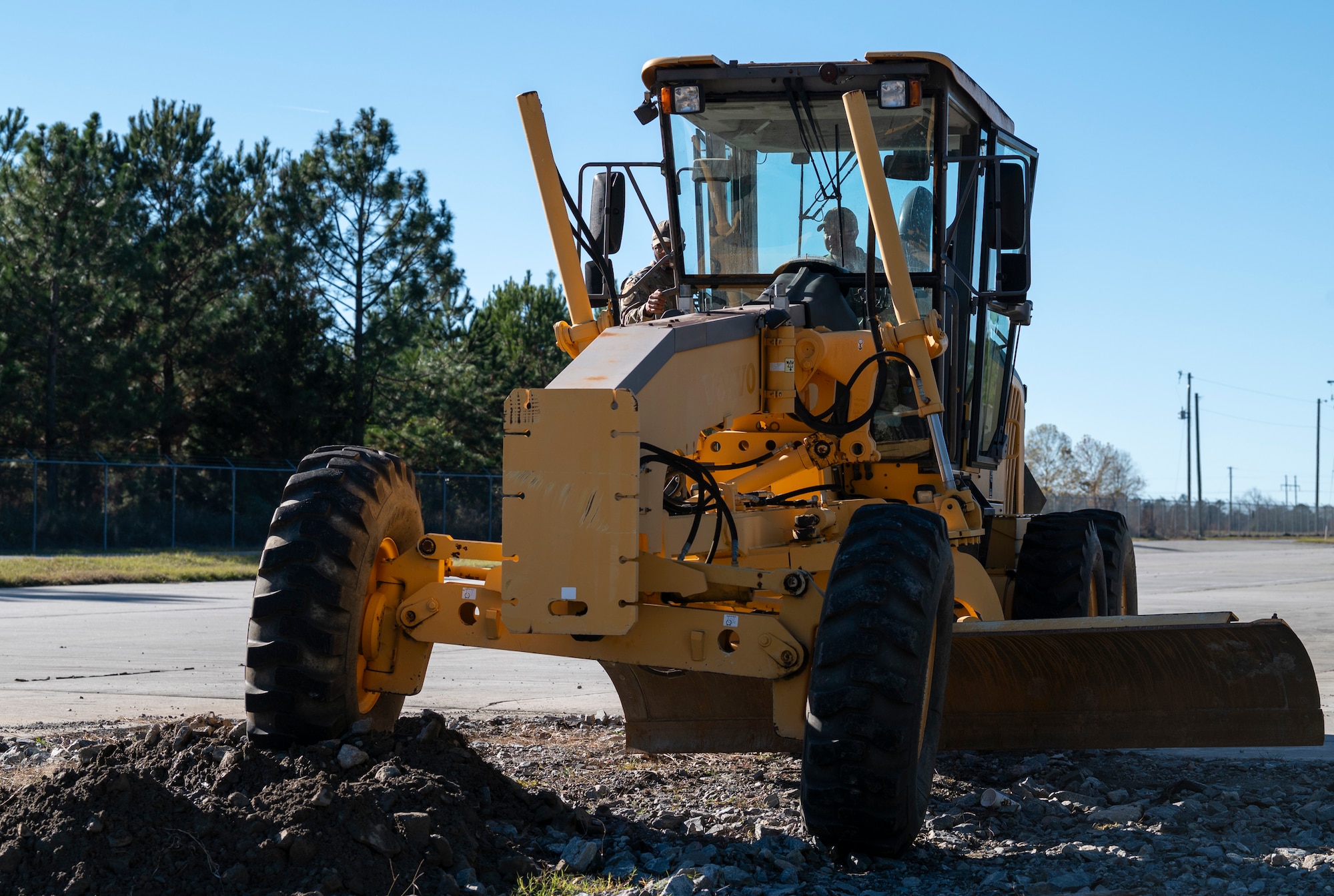 U.S. Air Force Col. Paul Sheets, 23rd Wing commander, operates a grader