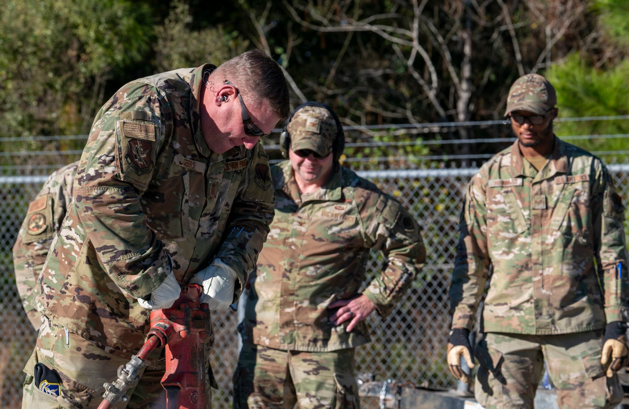U.S. Air Force Chief Master Sgt. Justin Geers, 23rd Wing command chief, operates a jackhammer
