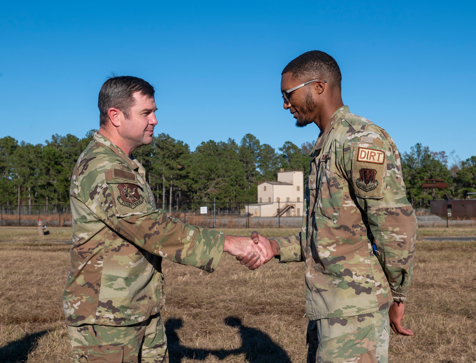 U.S. Air Force Col. Paul Sheets, 23rd Wing commander, left, coins Staff Sgt. Markiel Hubbard