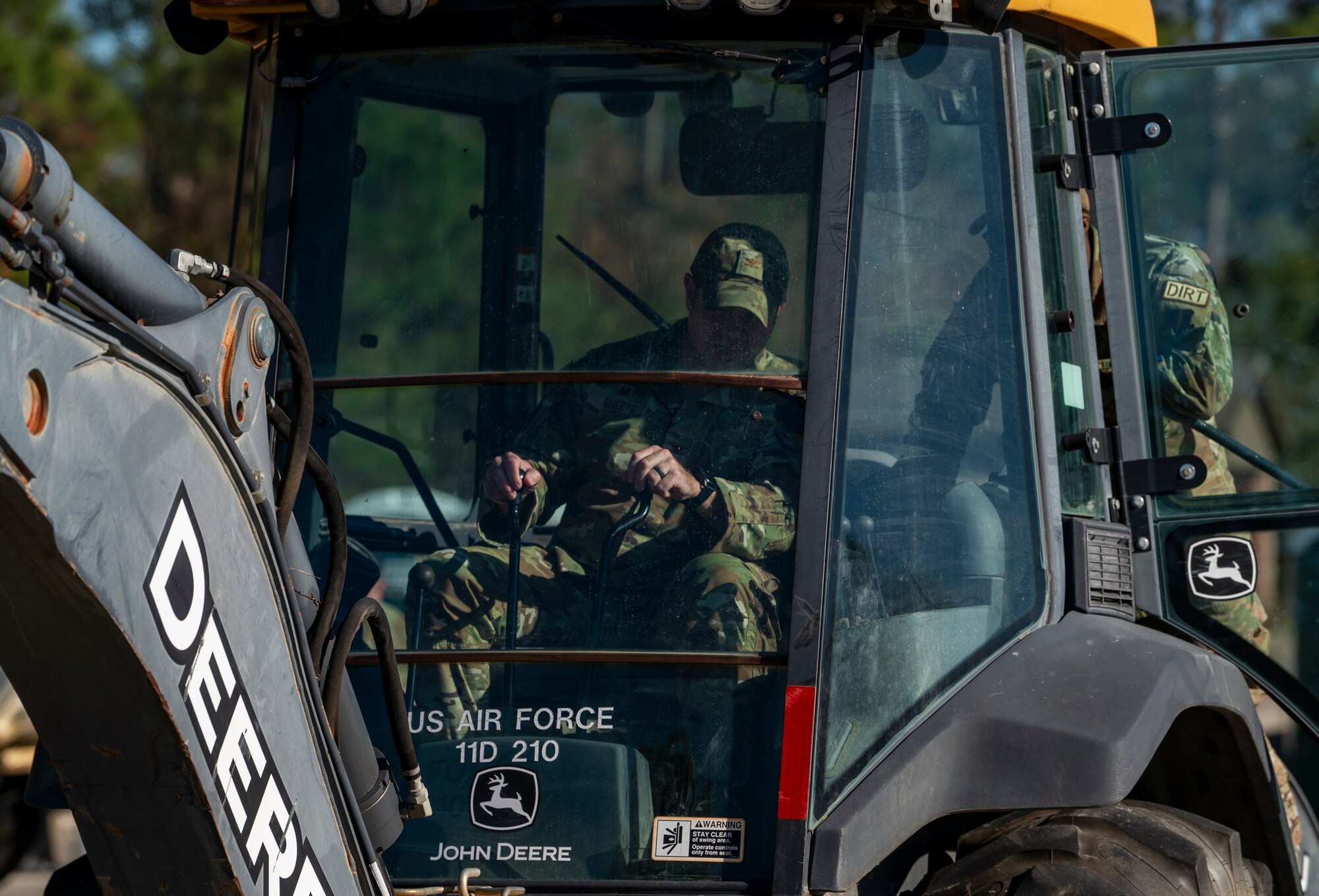 U.S. Air Force Col. Paul Sheets, 23rd Wing commander, operates a backhoe