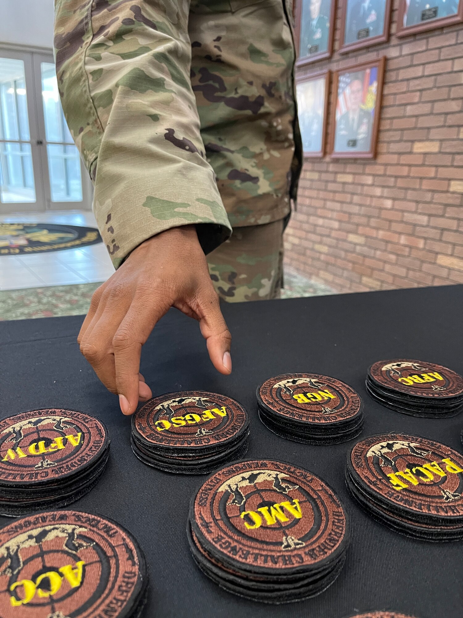 arm grabbing a badge for Defender Challenge reading AFGSC