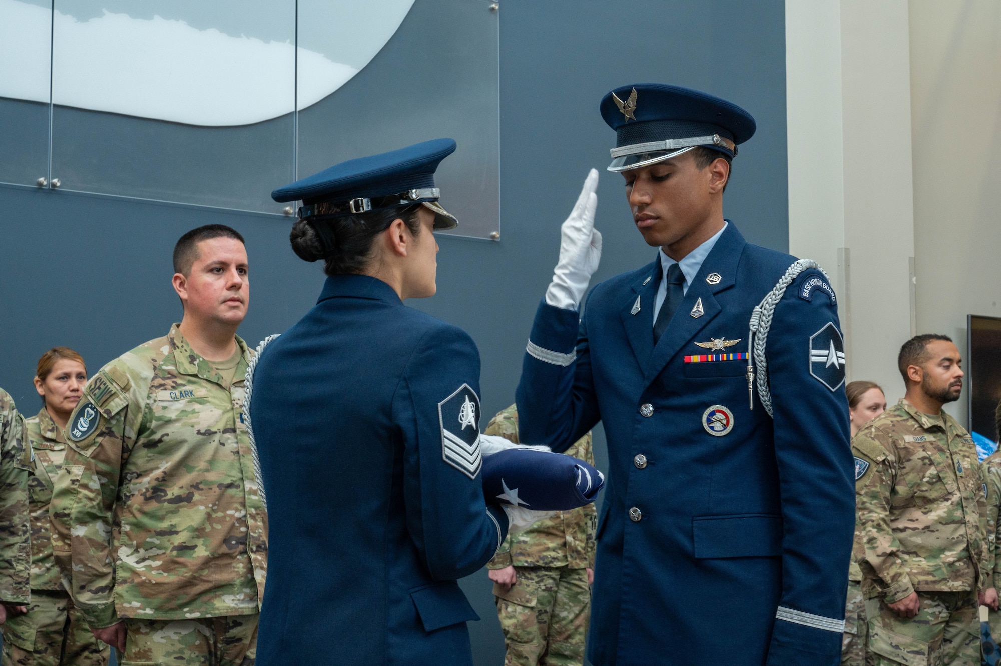 A member of the Peterson Space Force Base color guard salutes one of three flags distributed during the 16th Electromagnetic Warfare Squadron’s Flag Folding Ceremony at Peterson SFB Dec. 7, 2023. The ceremony celebrated Guardians and Air Force Reservists from the 160th, 161st, and 162d Deployment teams ahead of their upcoming deployments.