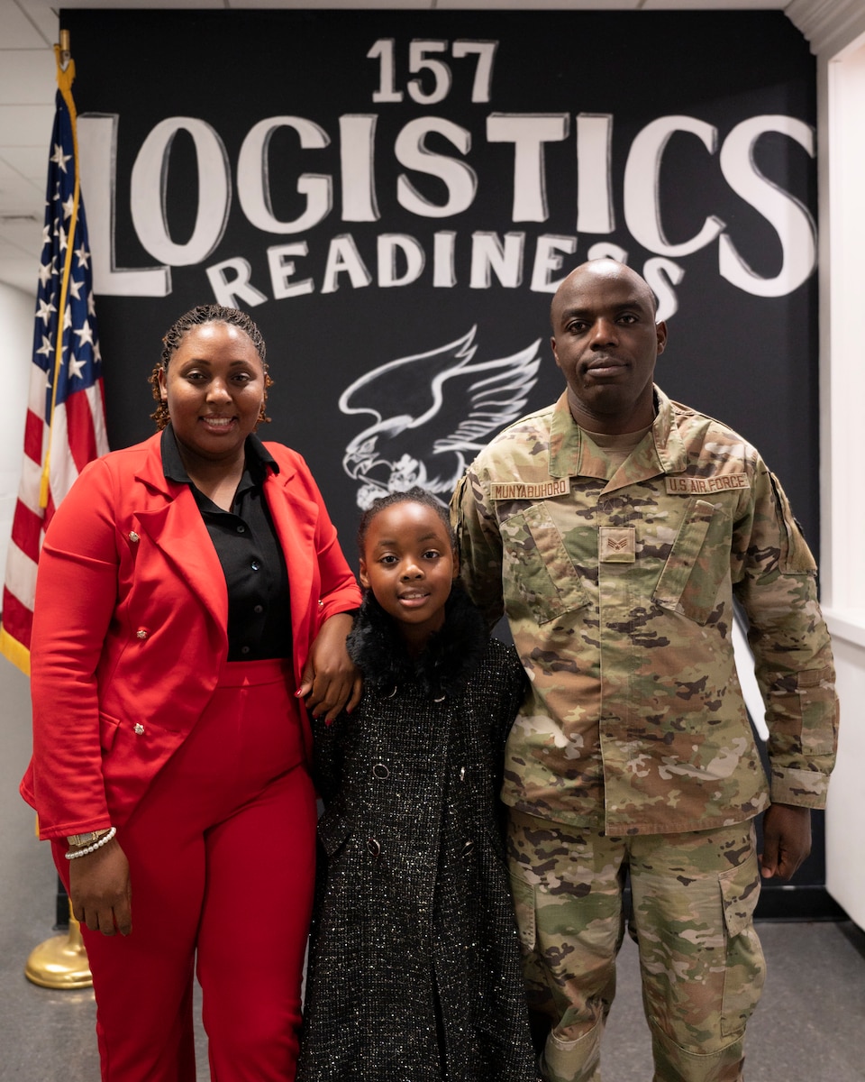 Senior Airman Theogene Munyabuhoro, a member of the Traffic Management Office with the 157th Logistics Readiness Squadron, enjoys the holiday drill with his wife Rose and daughter Marina, Dec. 3, 2023 at Pease Air National Guard Base, New Hampshire. Munyabuhoro and his family were invited to speak with First Lady Dr. Jill Biden at her roundtable discussion for National Guard leaders and families. (U.S. Air National Guard photo by Tech. Sgt. Victoria Nelson)