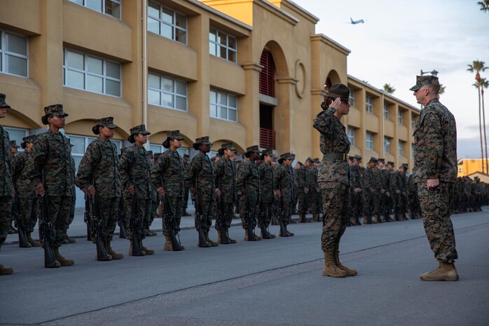 U.S. Marine Corps Sgt. Micah Shull, a drill instructor with Lima Company, 3rd Recruit Training Battalion, reports to Lt. Col. Matthew Phelps, the 3rd battalion commander, for the battalion commander's inspection at Marine Corps Recruit Depot San Diego, Dec.13, 2023. The battalion commander’s inspection surveys new Marines knowledge, bearing, and attention to detail as one of their last tests before graduating. (U.S. Marine Corps photo by Lance Cpl. Sarah M. Grawcock)