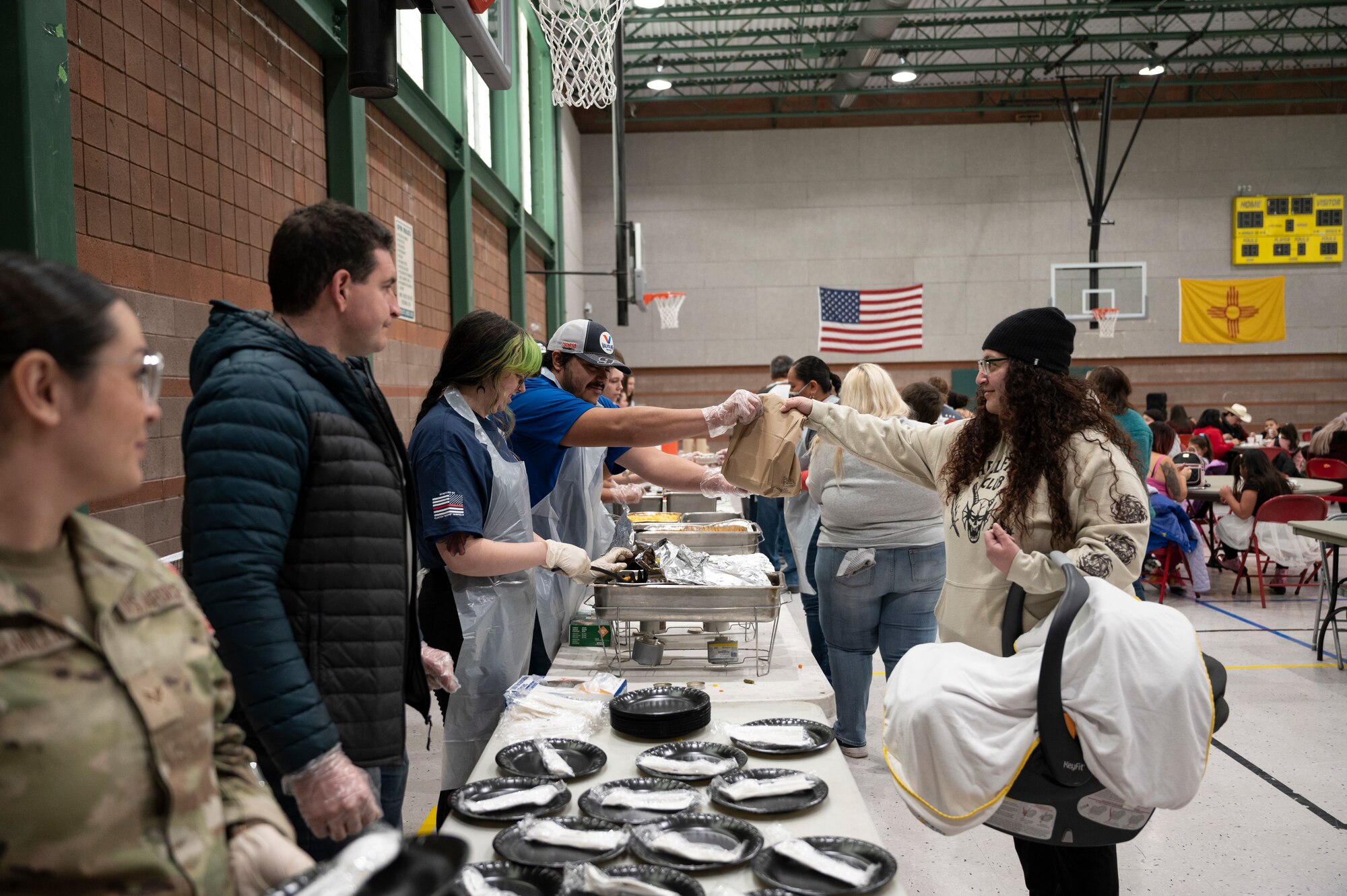 A group of people receive food.