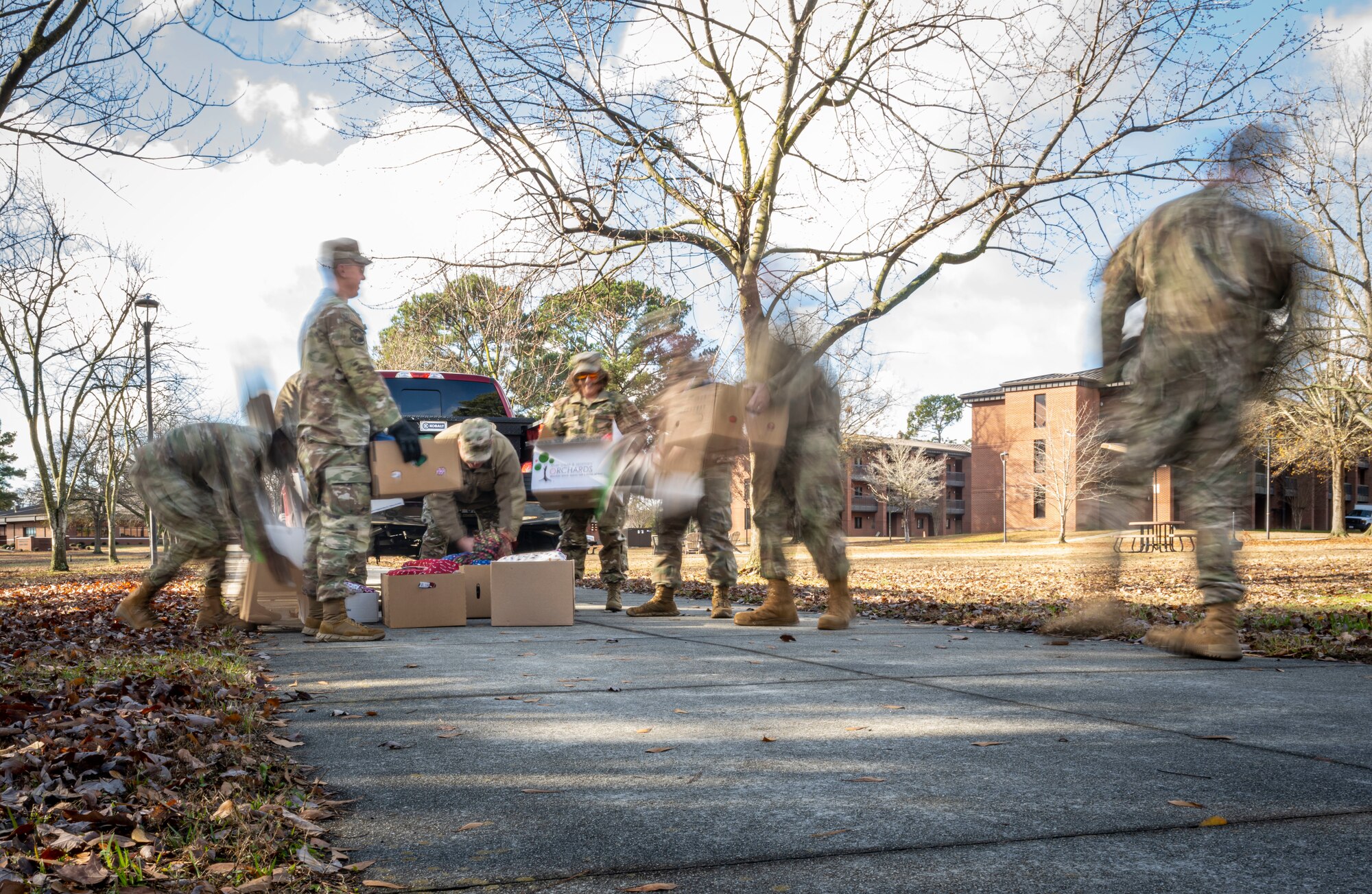 U.S. Airmen assigned to the 4th Fighter Wing unload vehicles to distribute holiday gift bags at Seymour Johnson Air Force Base, North Carolina, Dec. 11, 2023. Seymour Johnson first sergeant’s delivered over 700 gift bags to dorm Airmen for the holidays. (U.S Air Force photo by Senior Airman Sabrina Fuller-Judd)