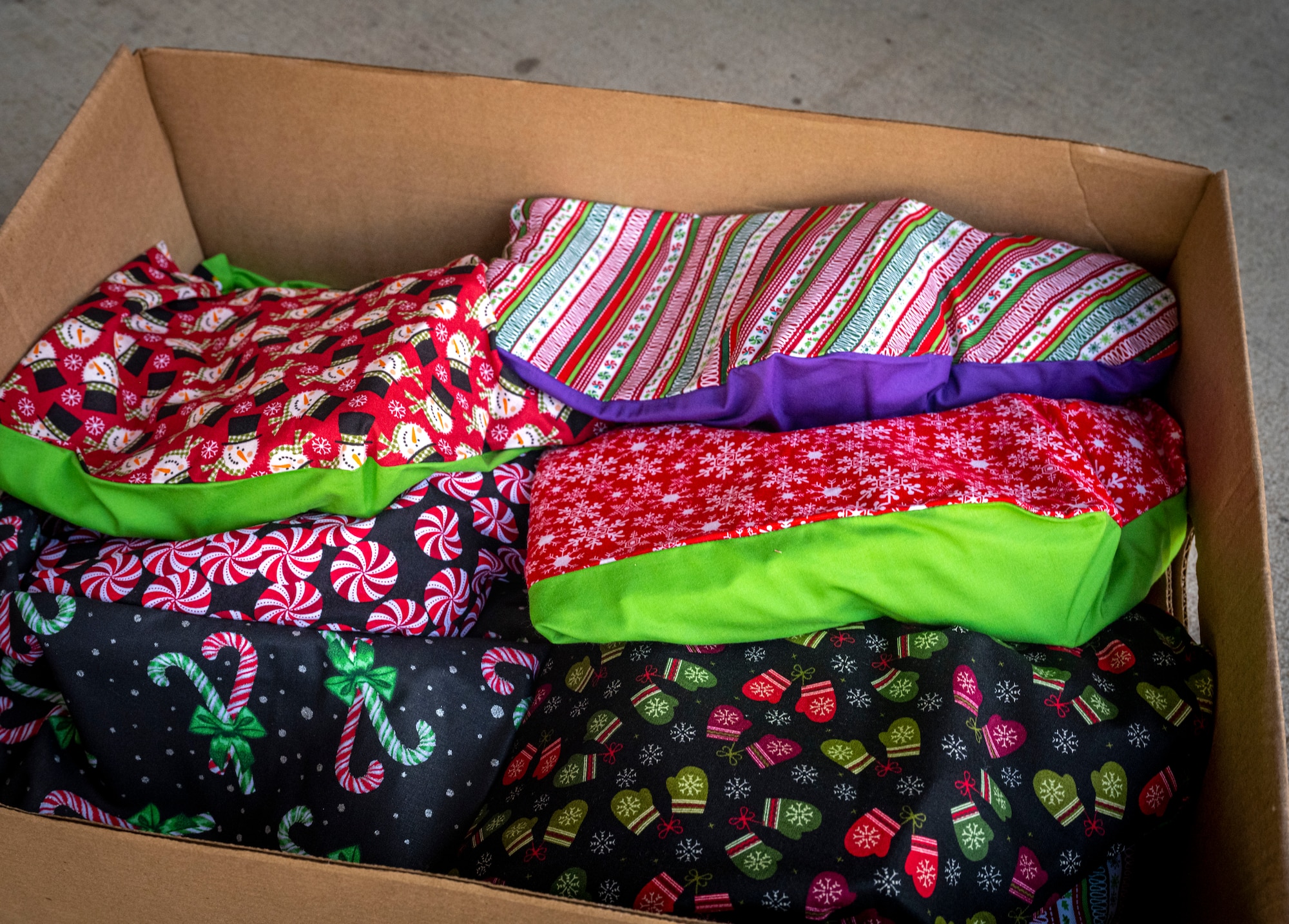 A box of holiday gift bags prepare to be distributed to dorm Airmen at Seymour Johnson Air Force Base, North Carolina, Dec. 11, 2023. The gift bags included cookies, gift cards, and a holiday letter. (U.S Air Force photo by Senior Airman Sabrina Fuller-Judd)