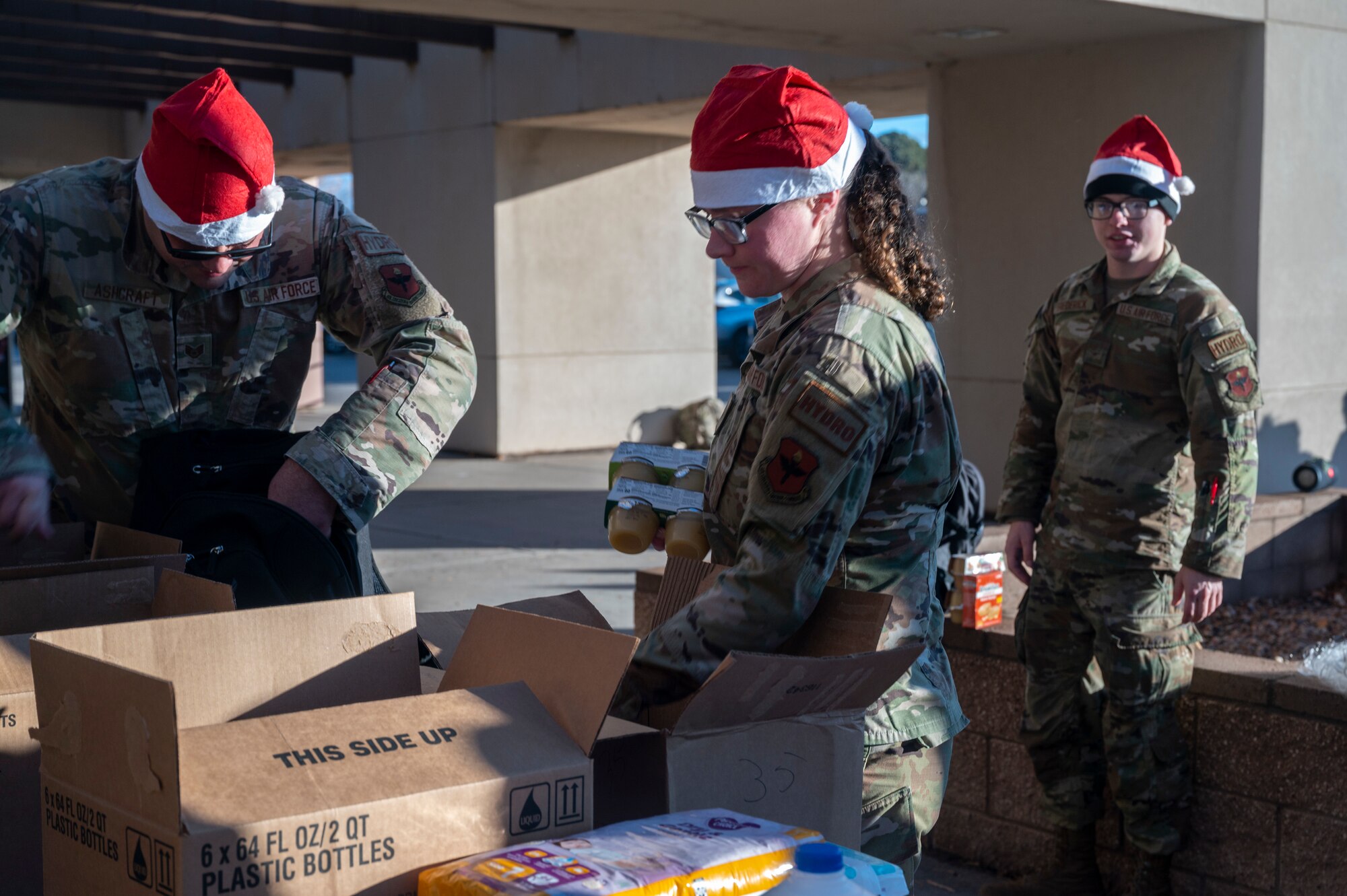 Woman puts donated food in a box.